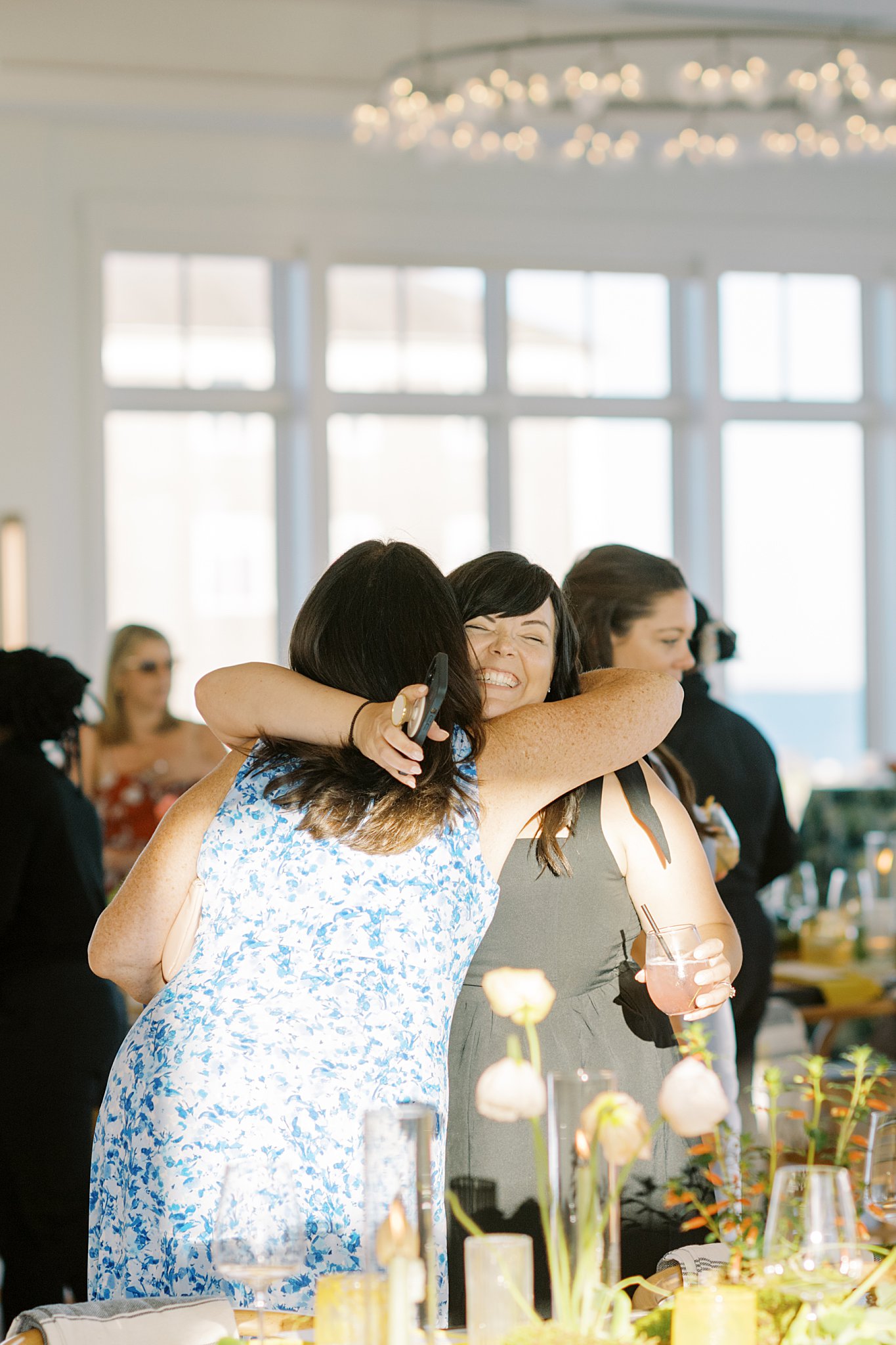 guests hug before dinner at Wychmere Boston Planners Dining Club