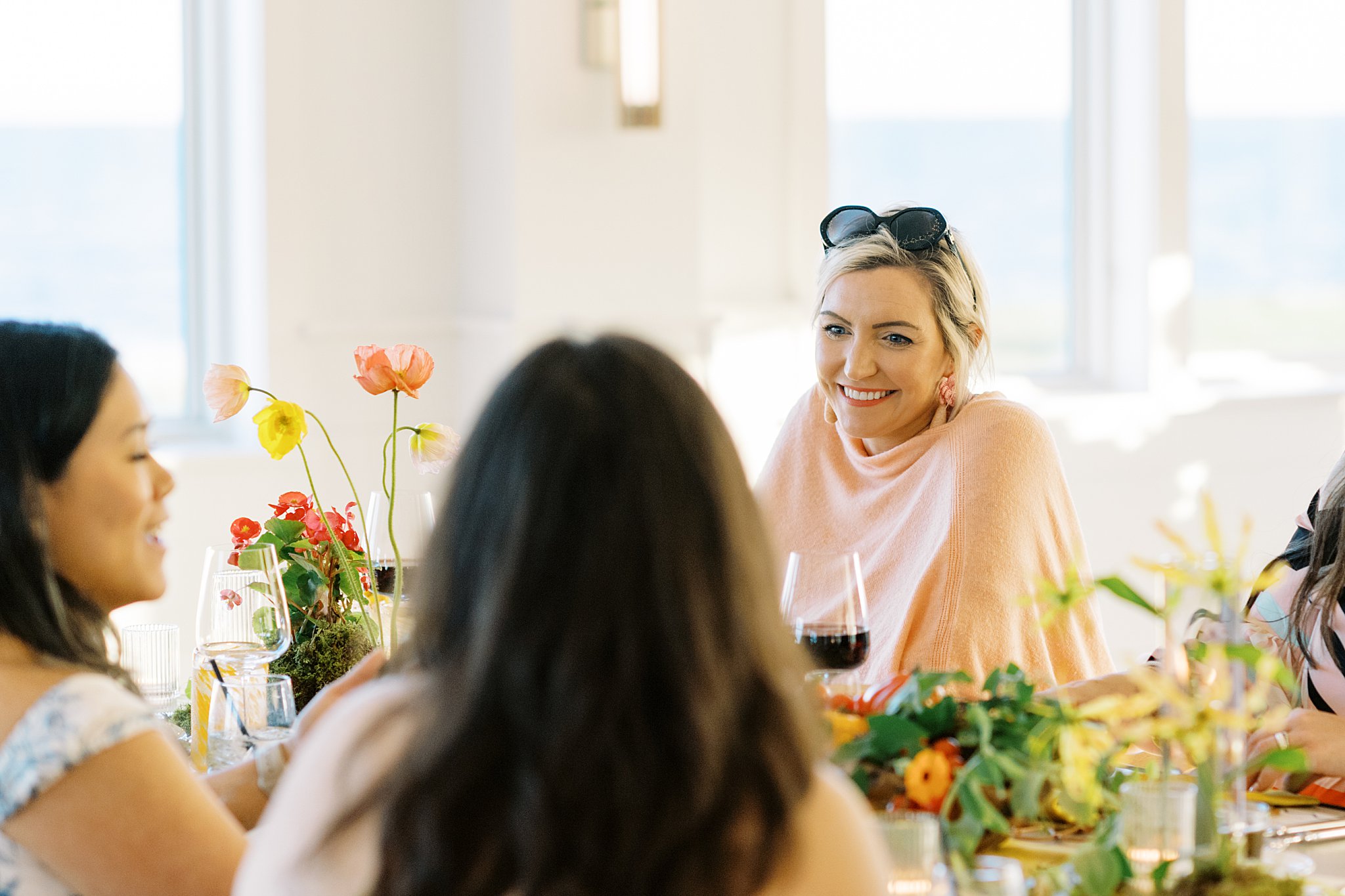 guests connect over dinner by Cape Cod wedding photographer