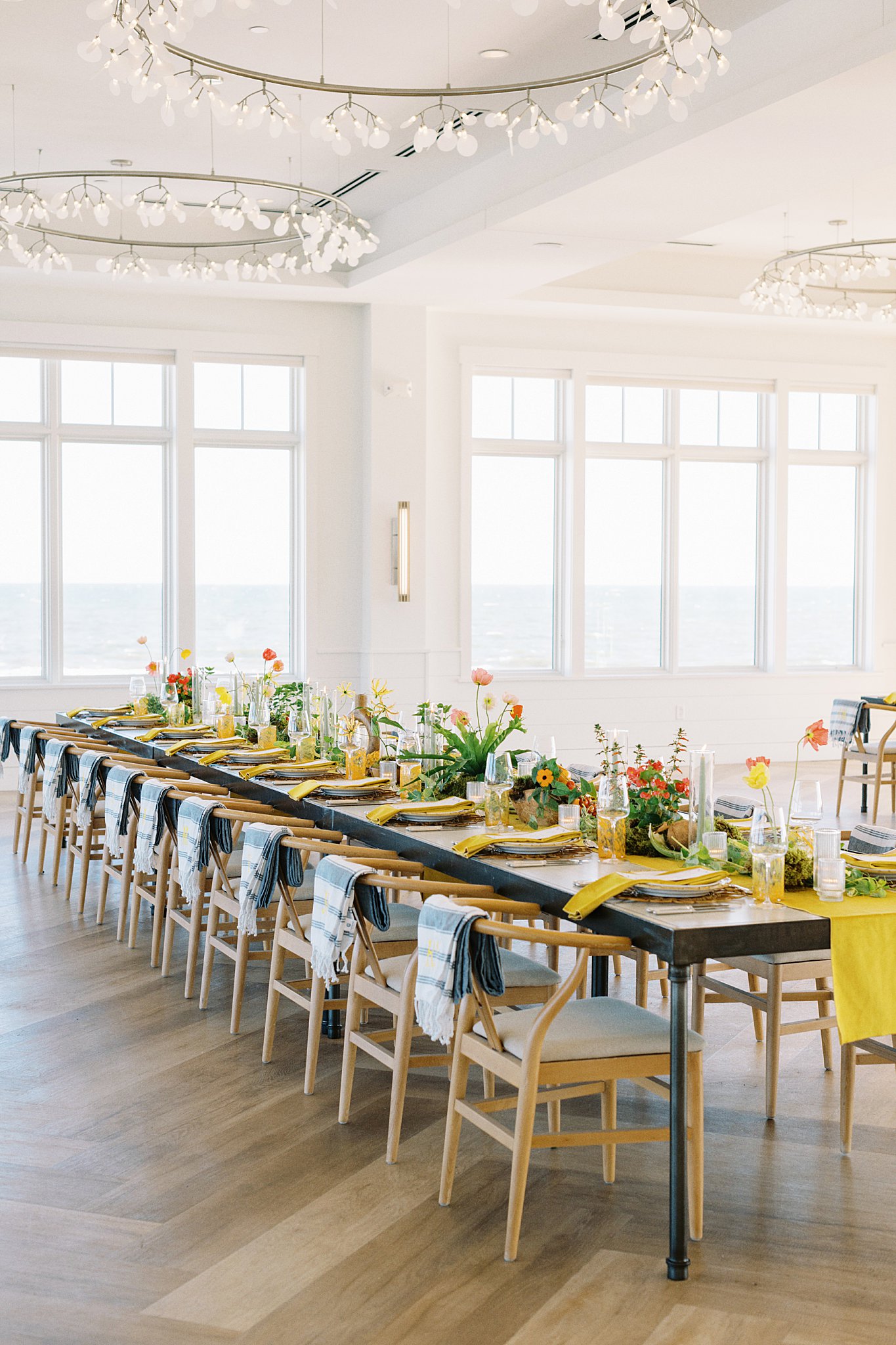 long, rectangle table set up with views of the ocean by Cape Cod wedding photographer