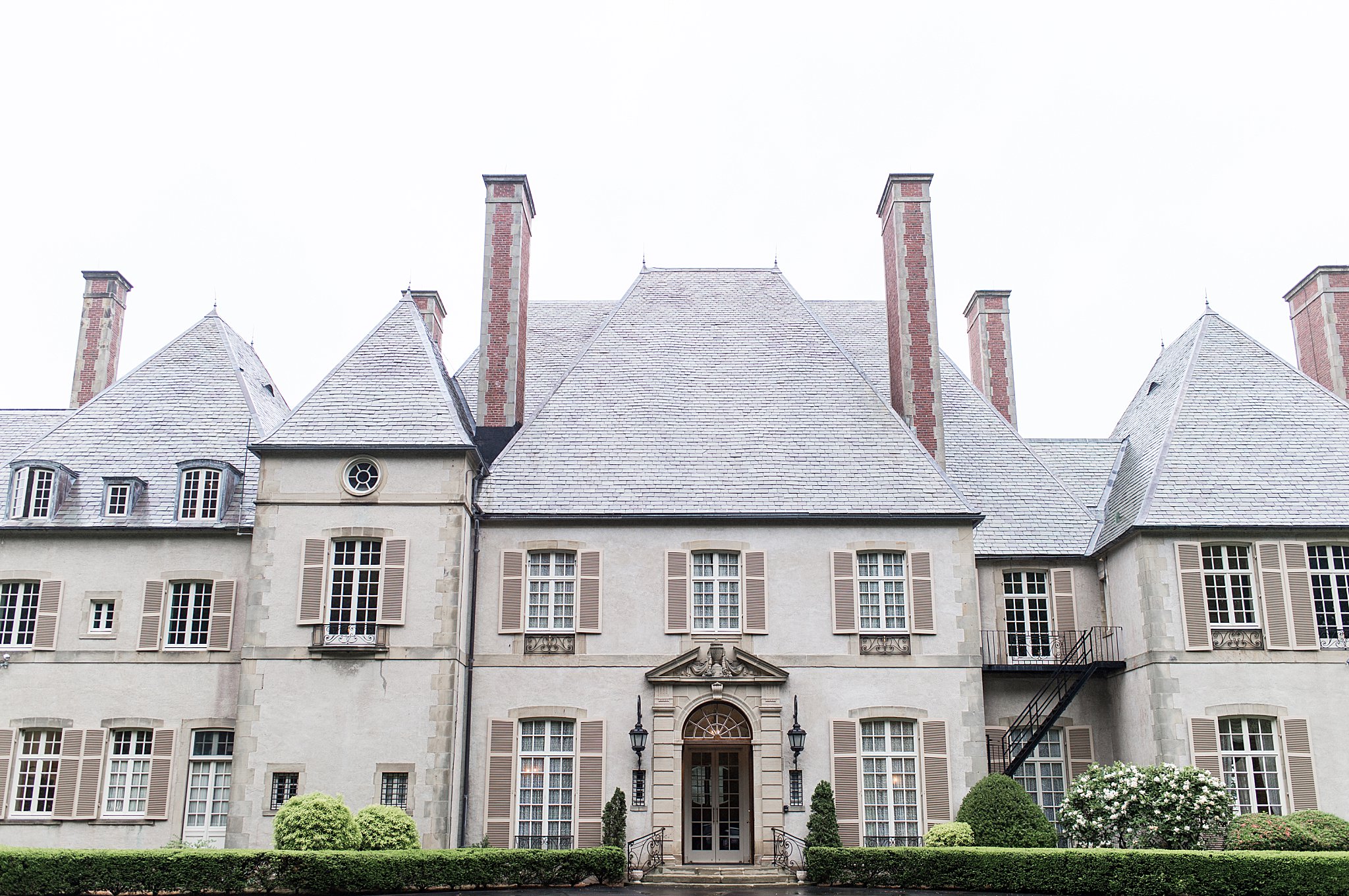 beige estate with large chimneys by Lynne Reznick Photography