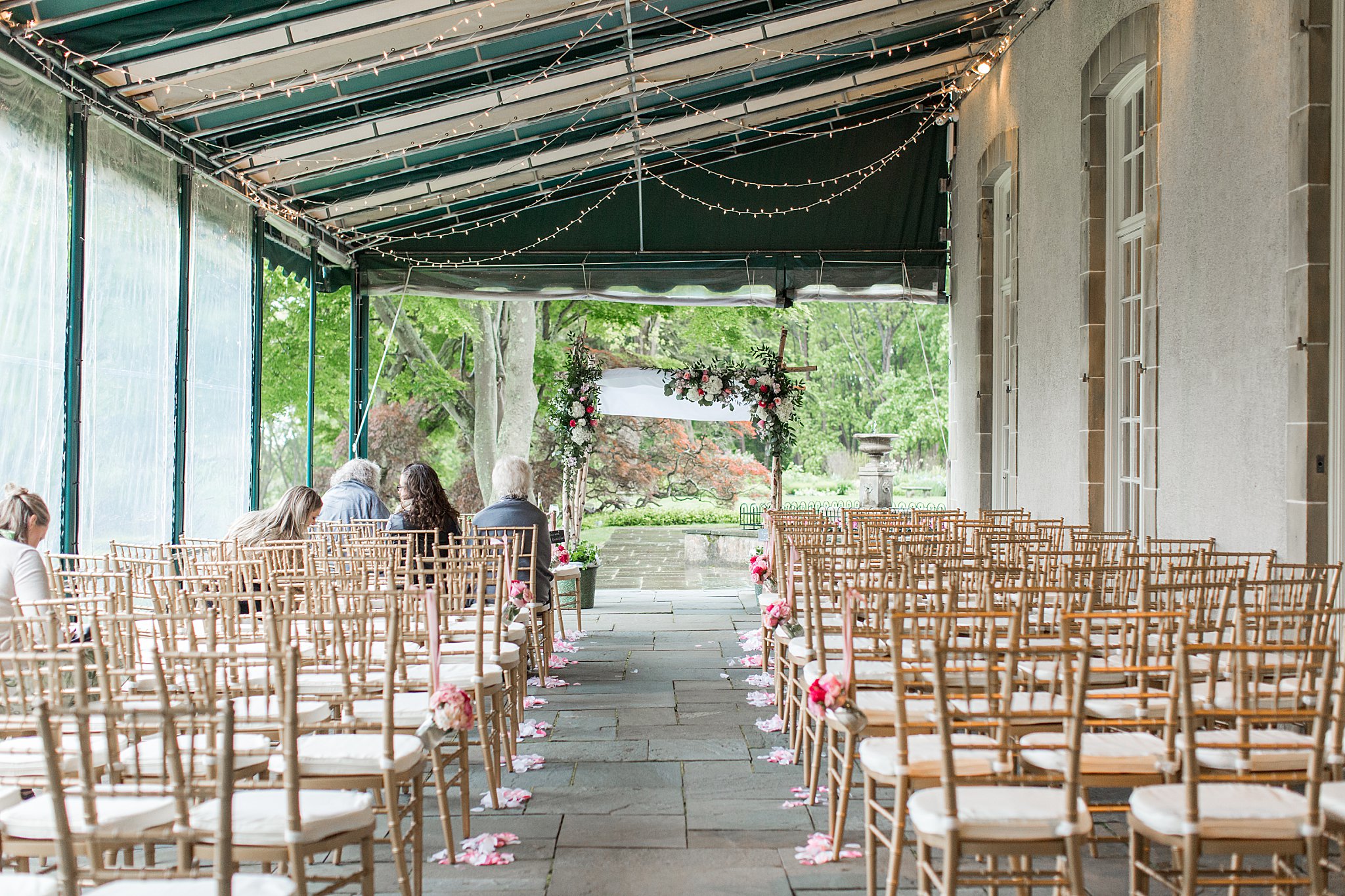 covered patio set up as rain backup by New England wedding photographer