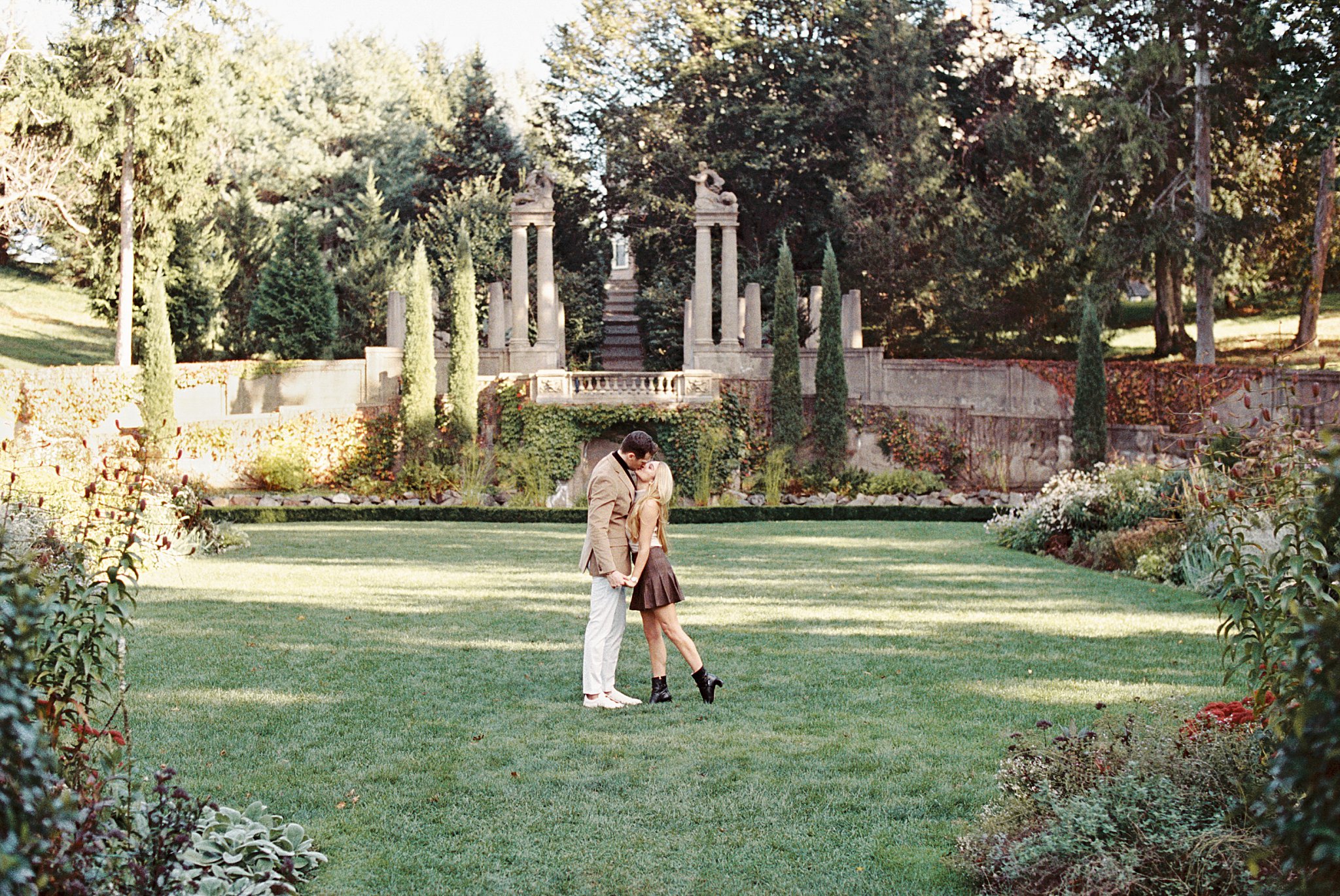 8 European-inspired Wedding Venues in New England includes garden property as couple kisses 