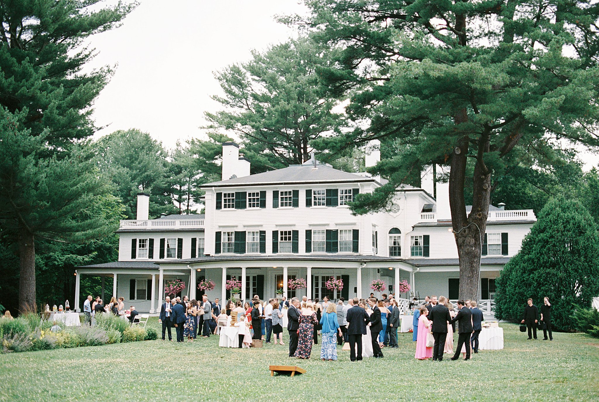 guests enjoy lawn games during cocktail hour at Glen Magna Farms wedding