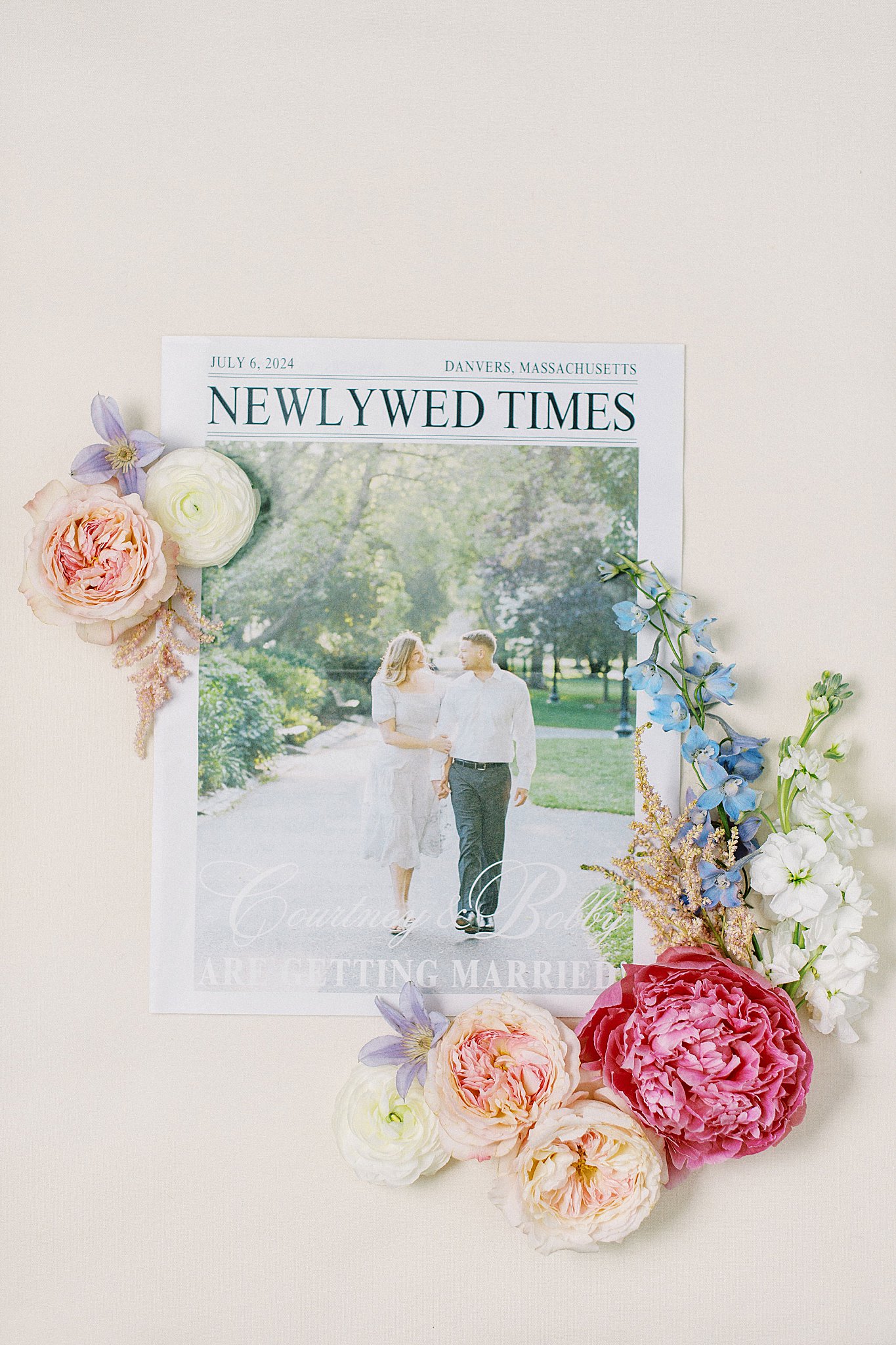 wedding program laid out with florals by Boston wedding photographer