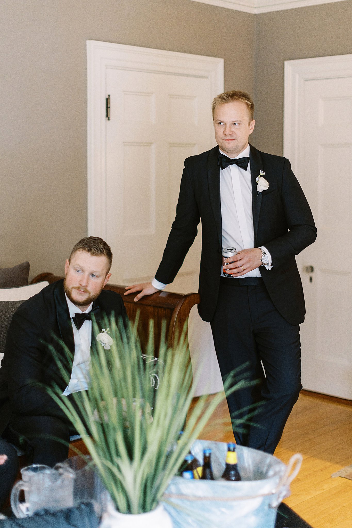 groomsmen look over to groom as they wait for ceremony by Lynne Reznick Photography