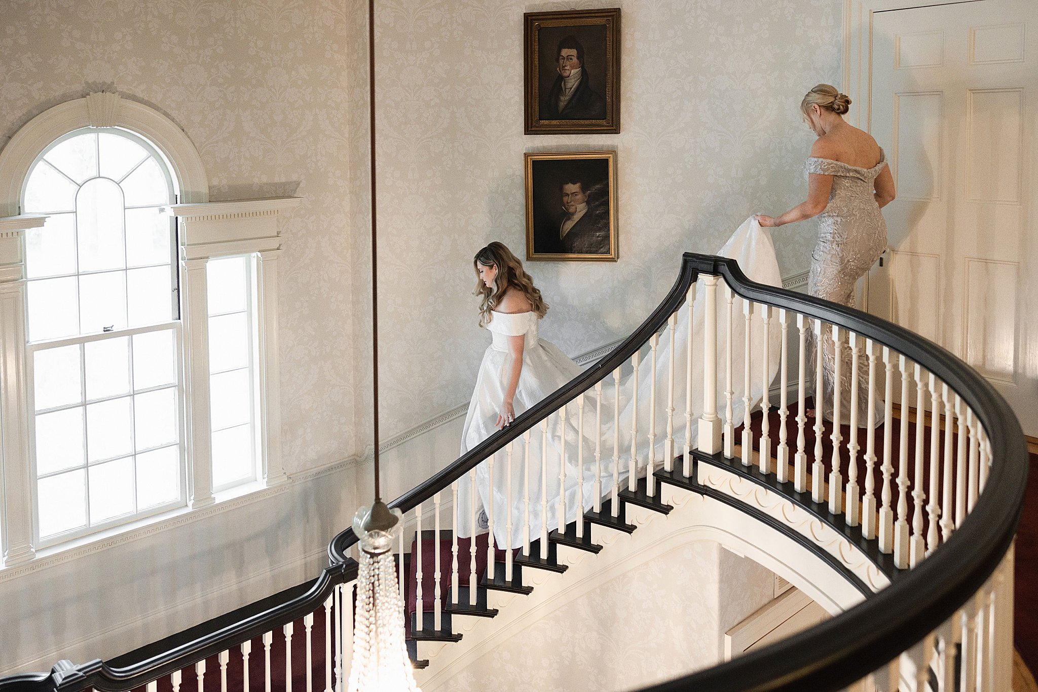 bride walks down stairs at Glen Magna Farms