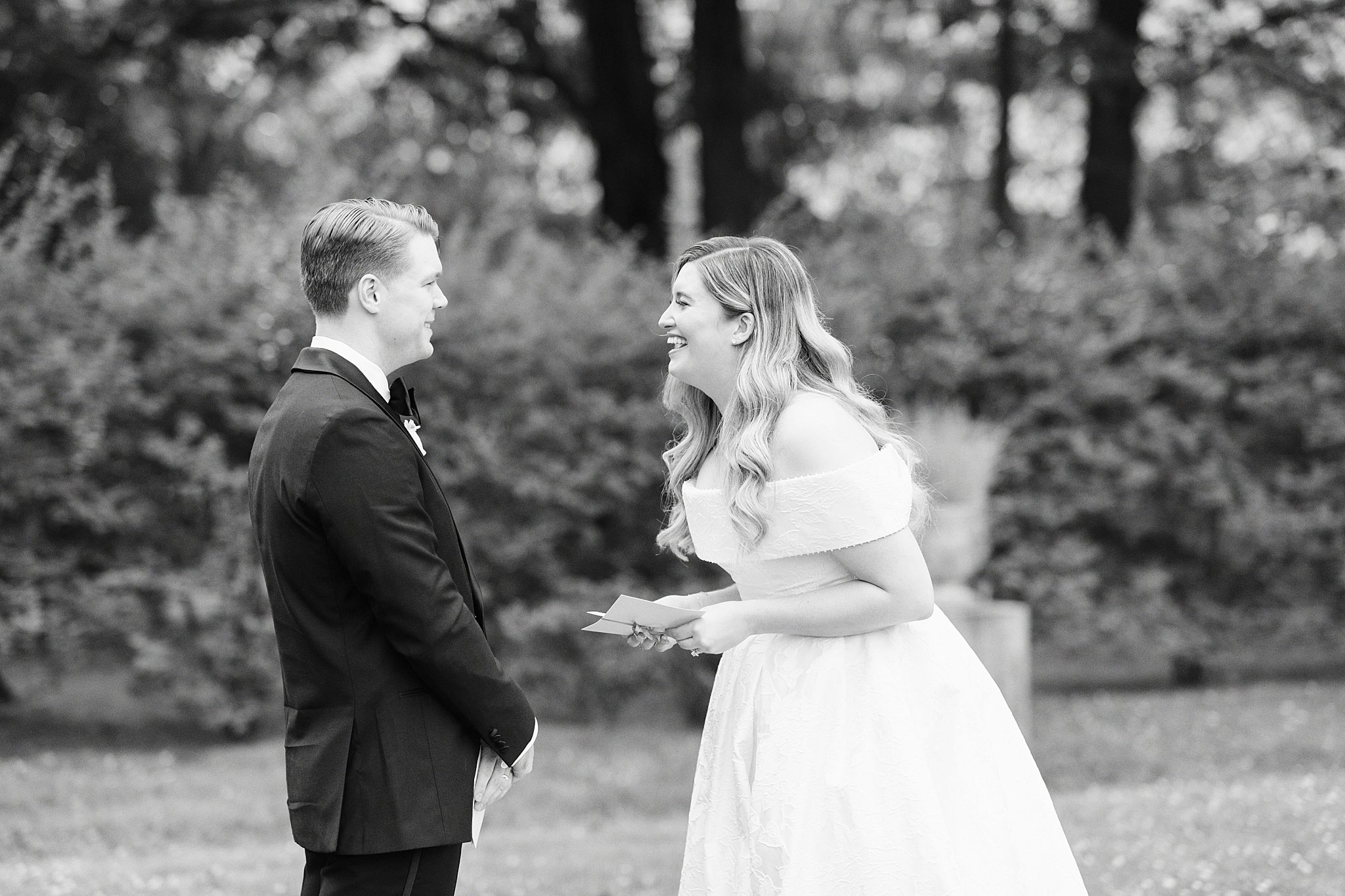 woman laughs as she shares vows with man by Boston wedding photographer