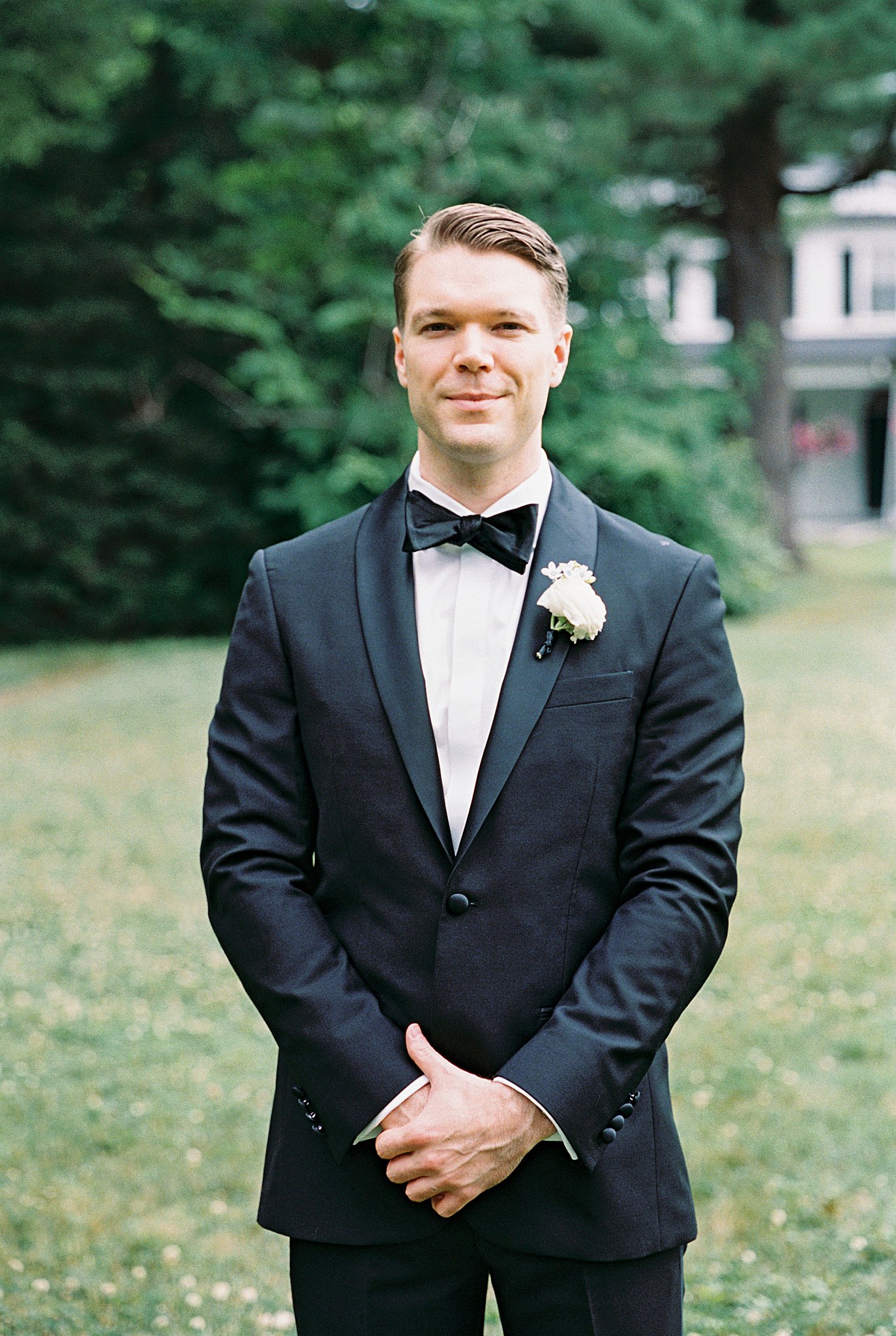 man smiles wearing a tux by Lynne Reznick Photography