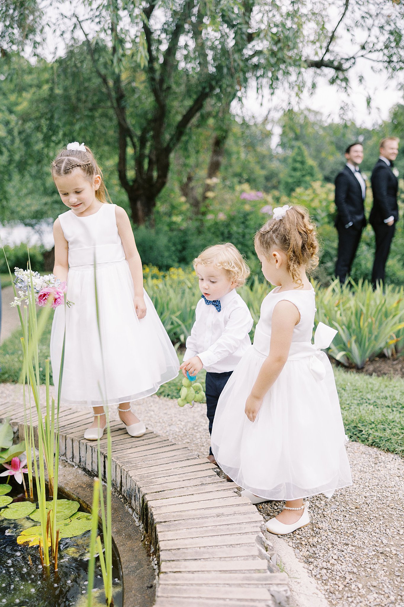 children play around fountain during family pictures at Glen Magna Farms