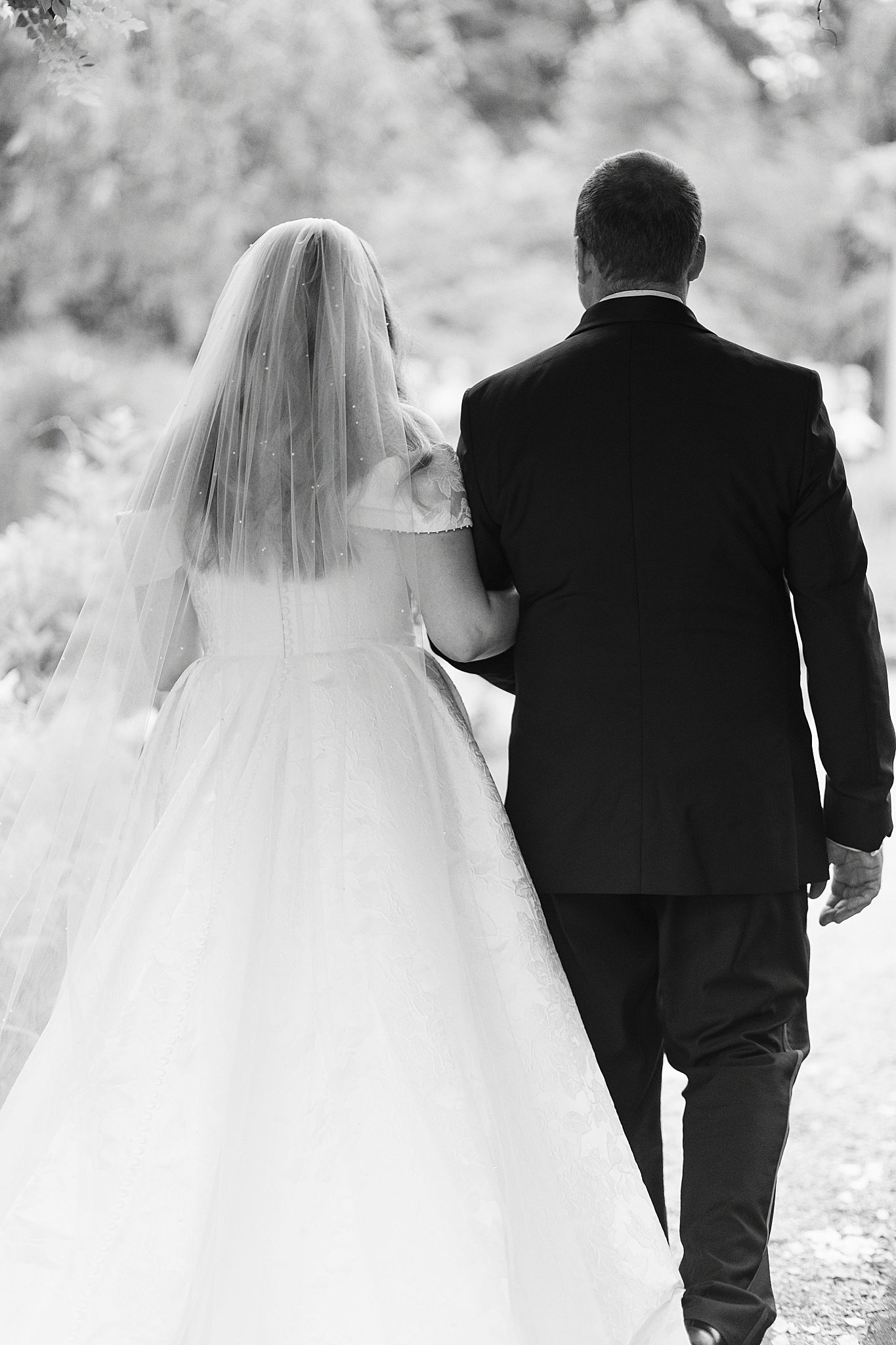 woman escorted down the aisle by her father by Lynne Reznick Photography