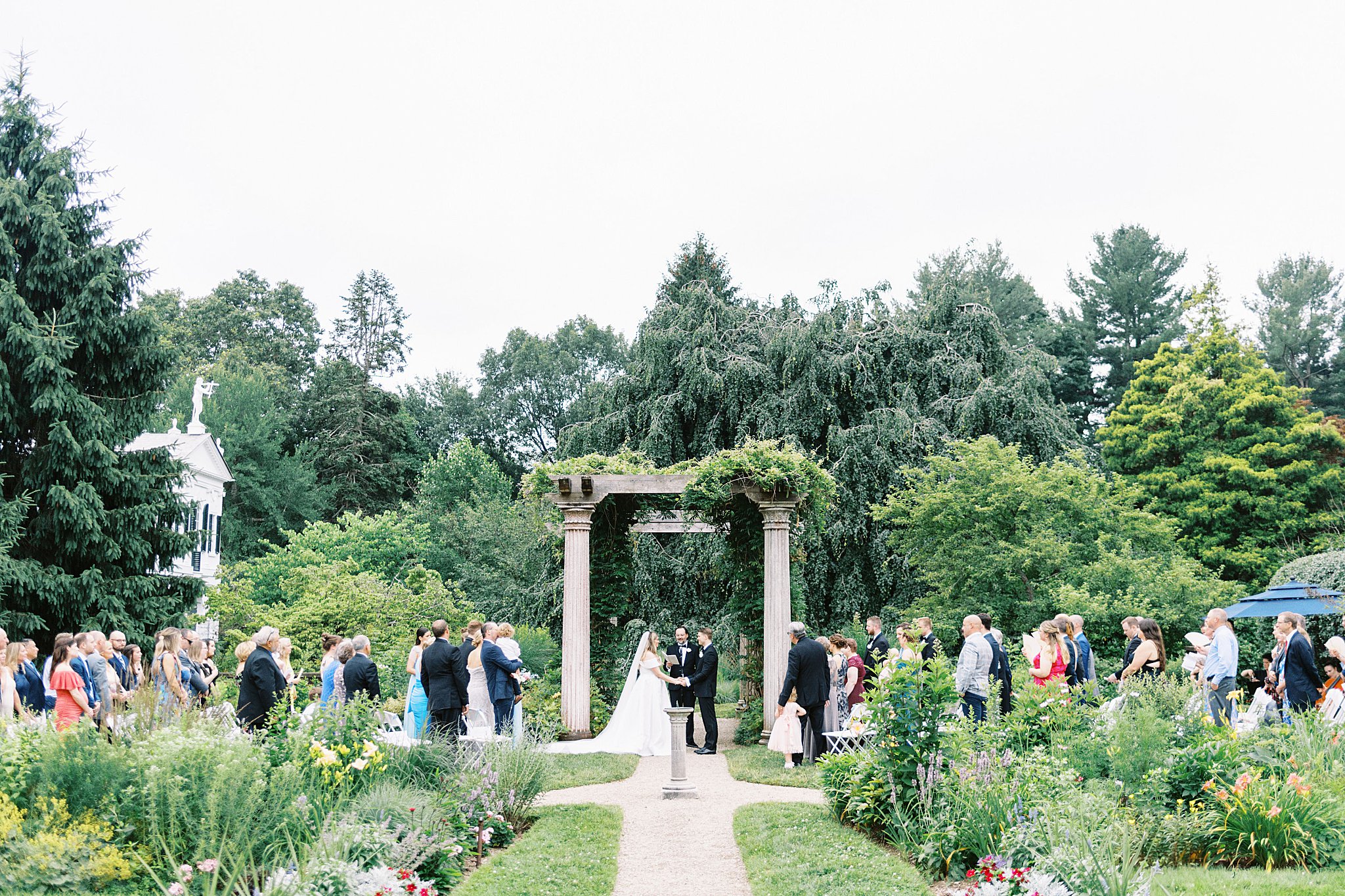 guests stand during exchange of vows at Glen Magna Farms