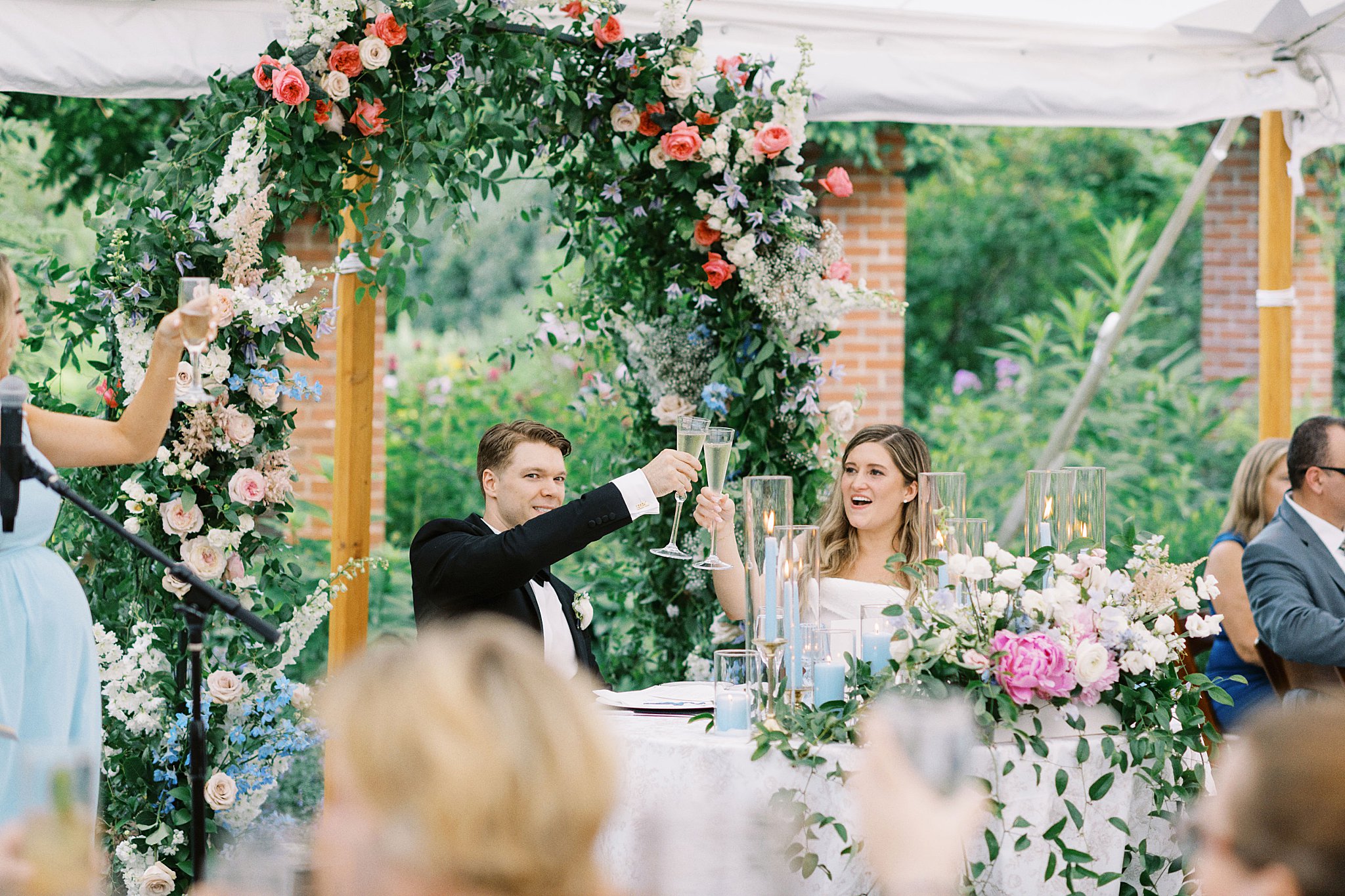 man and woman toast during speeches by Boston wedding photographer