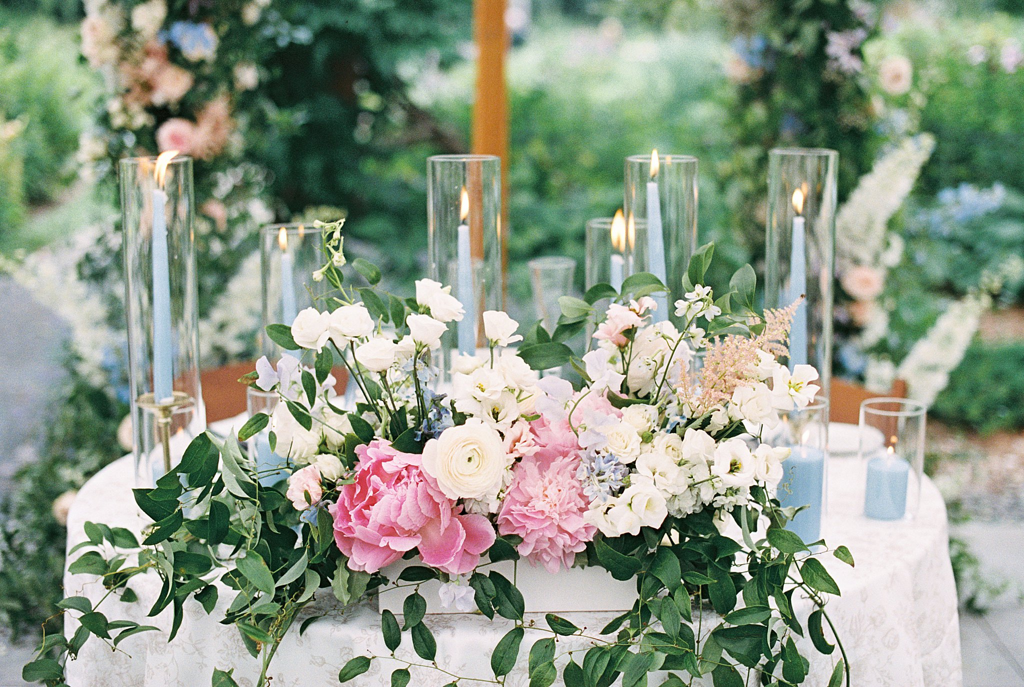 romantic florals and candles decorate sweetheart table at Glen Magna Farms