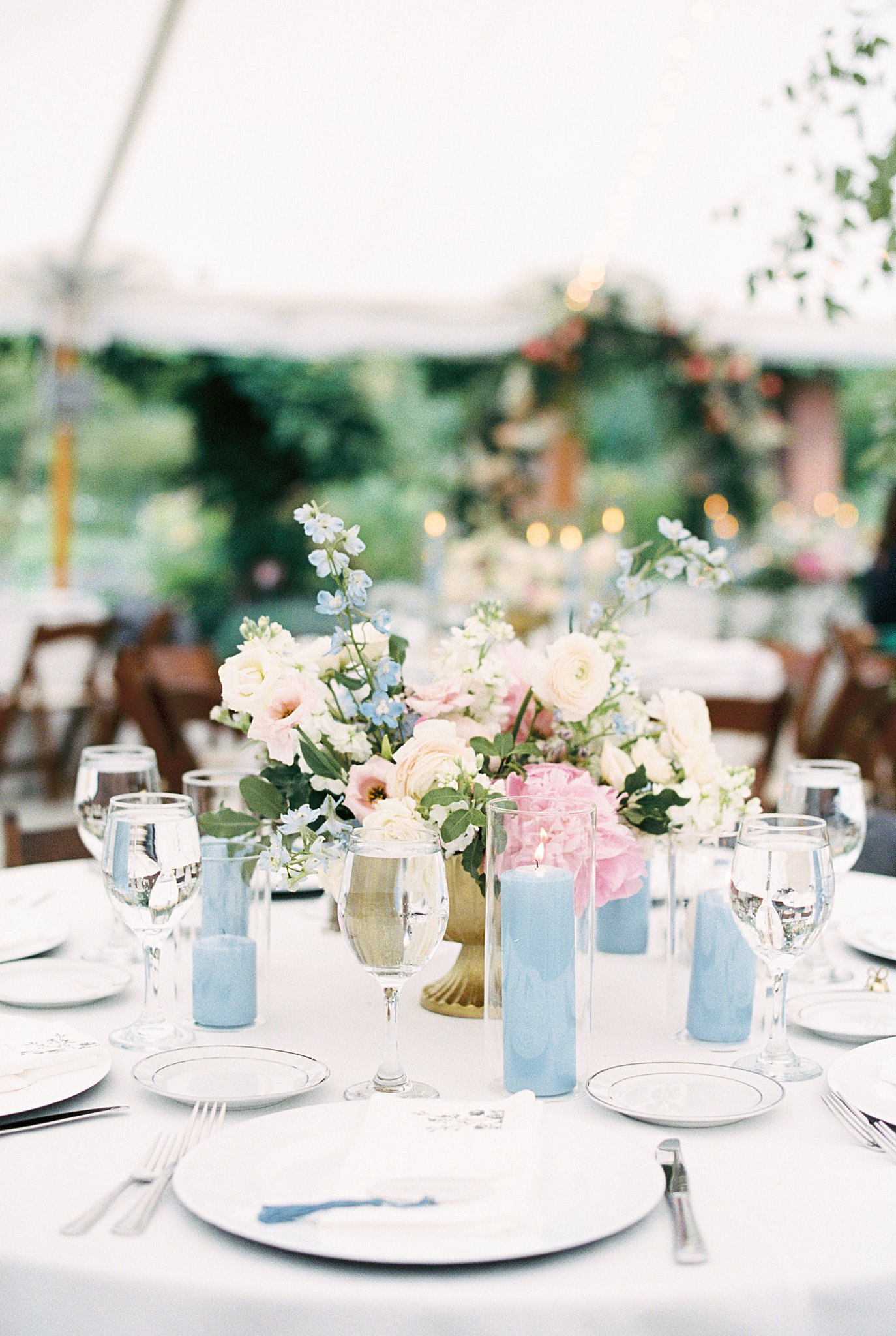 floral centerpiece is surrounded by candles by Boston wedding photographer