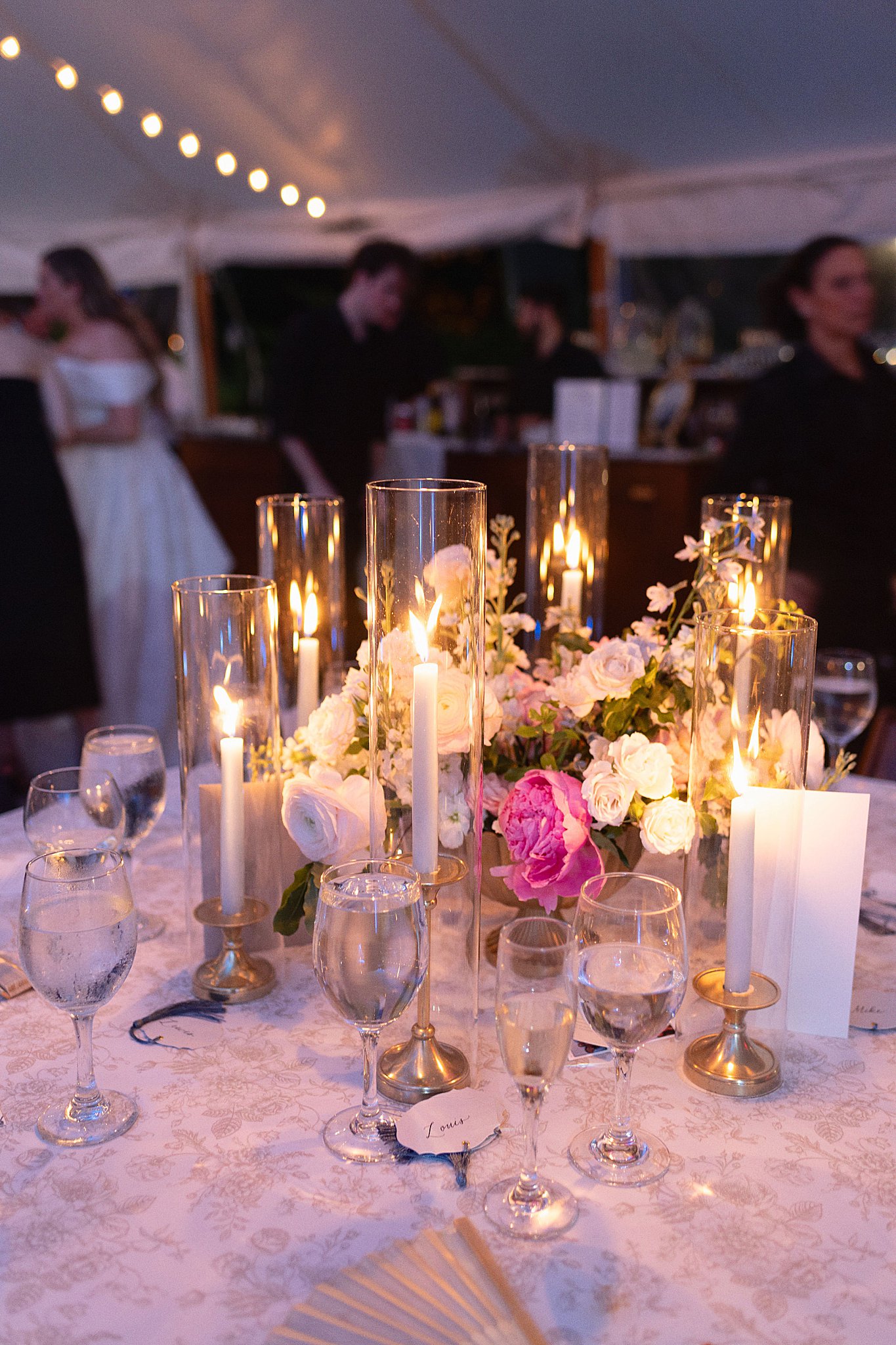 table glows with candlelight around floral centerpiece at Glen Magna Farms reception