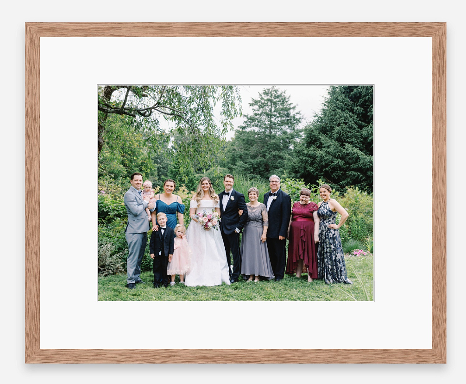 a happy family outdoors in a wooden frame for annual print & album sale