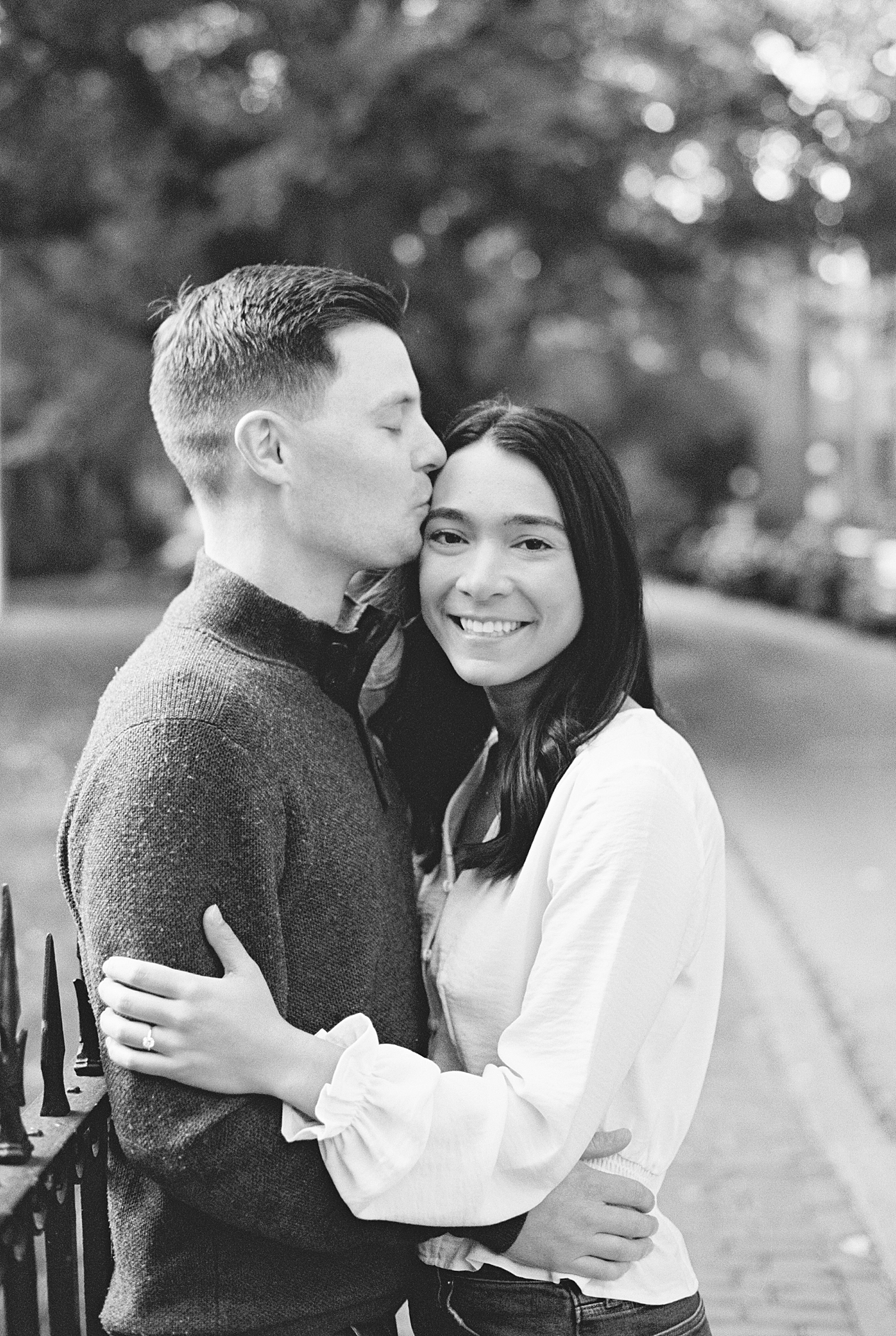 bride-to-be snuggles her fiance for Fan Pier Park Engagement Session