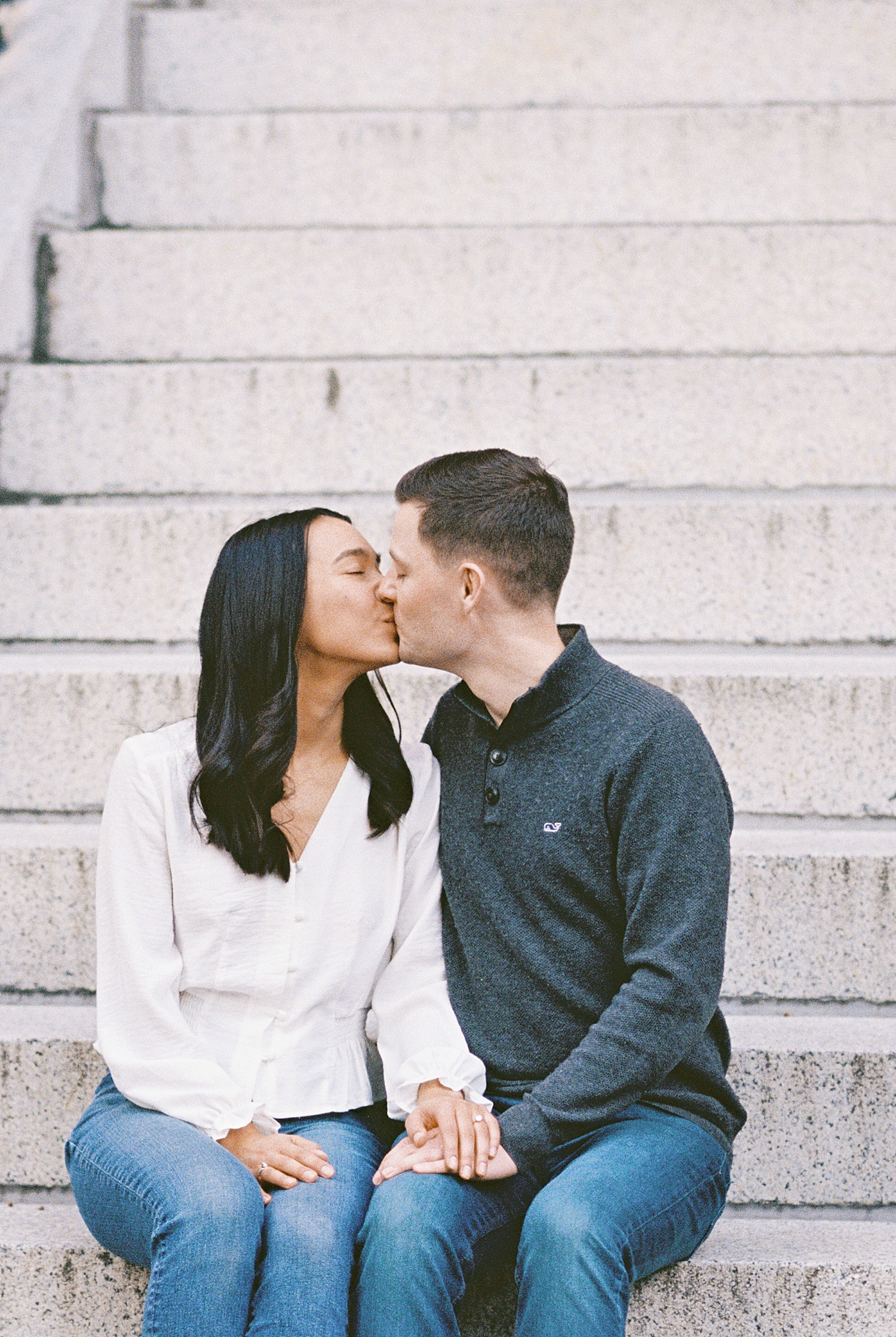 man and woman kiss on steps for Fan Pier Park Engagement Session