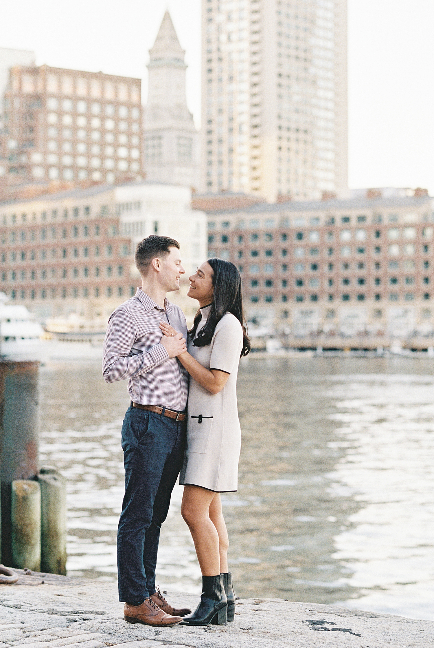 woman in white shift dress gazes at fiance by Lynne Reznick Photography