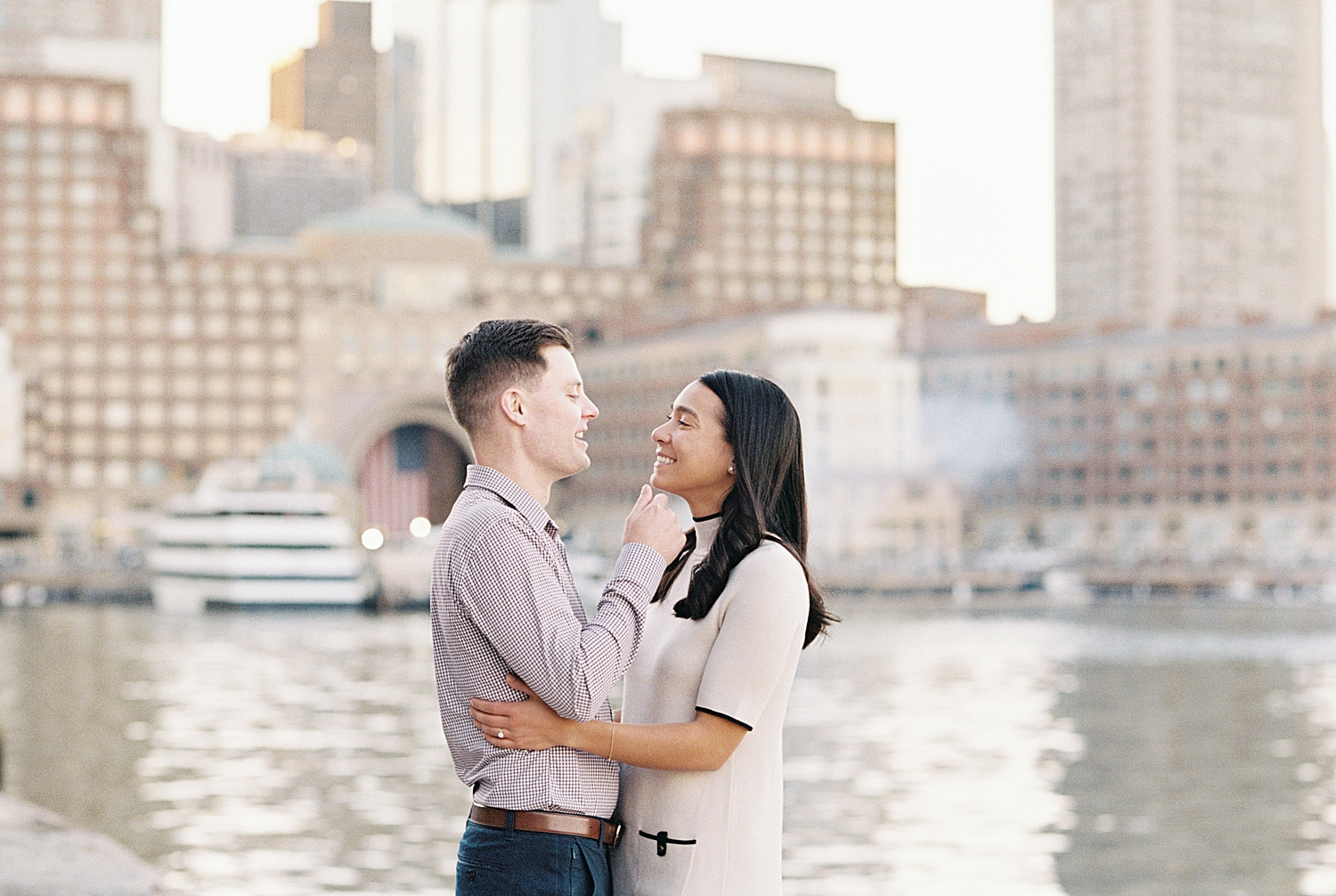 man pulls his woman close for a kiss by Boston Wedding Photographer