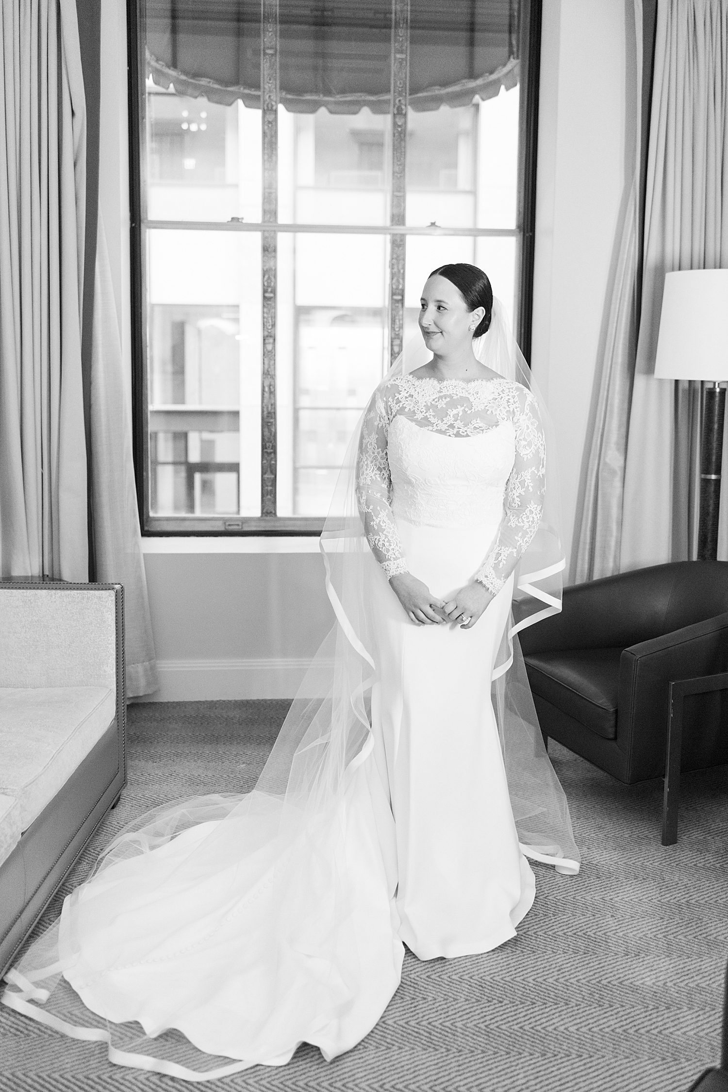 woman in lace white gown in front of window by Lynne Reznick Photography