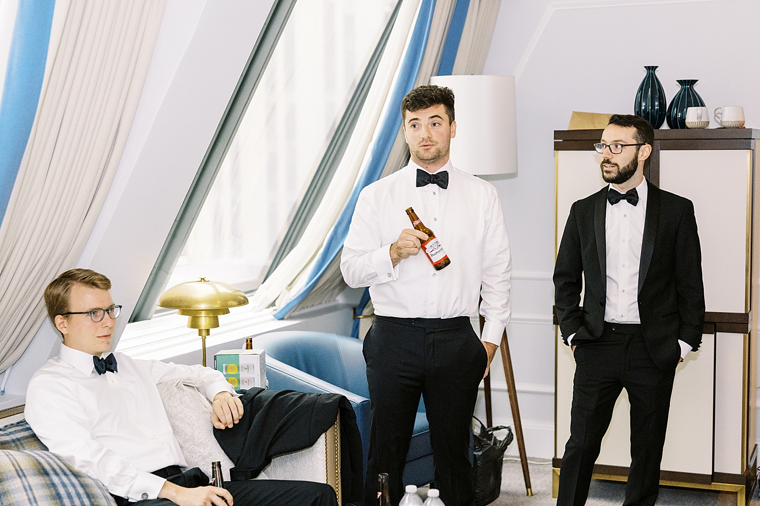 men drink beer in getting ready room at Langham Hotel