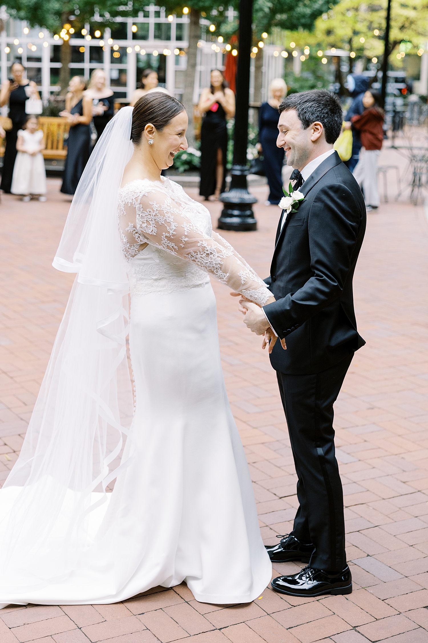 bride laughs as she shows her groom her dress by Lynne Reznick Photography