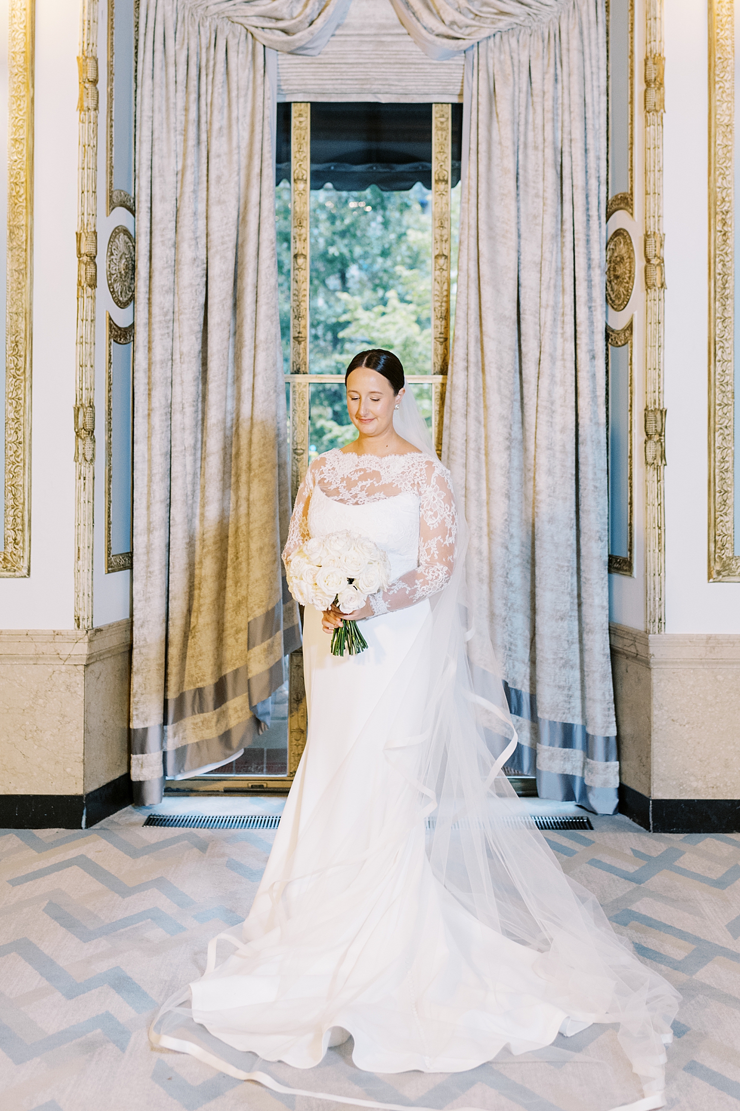 woman in white long gown stands by windows by Boston Wedding Photographer 