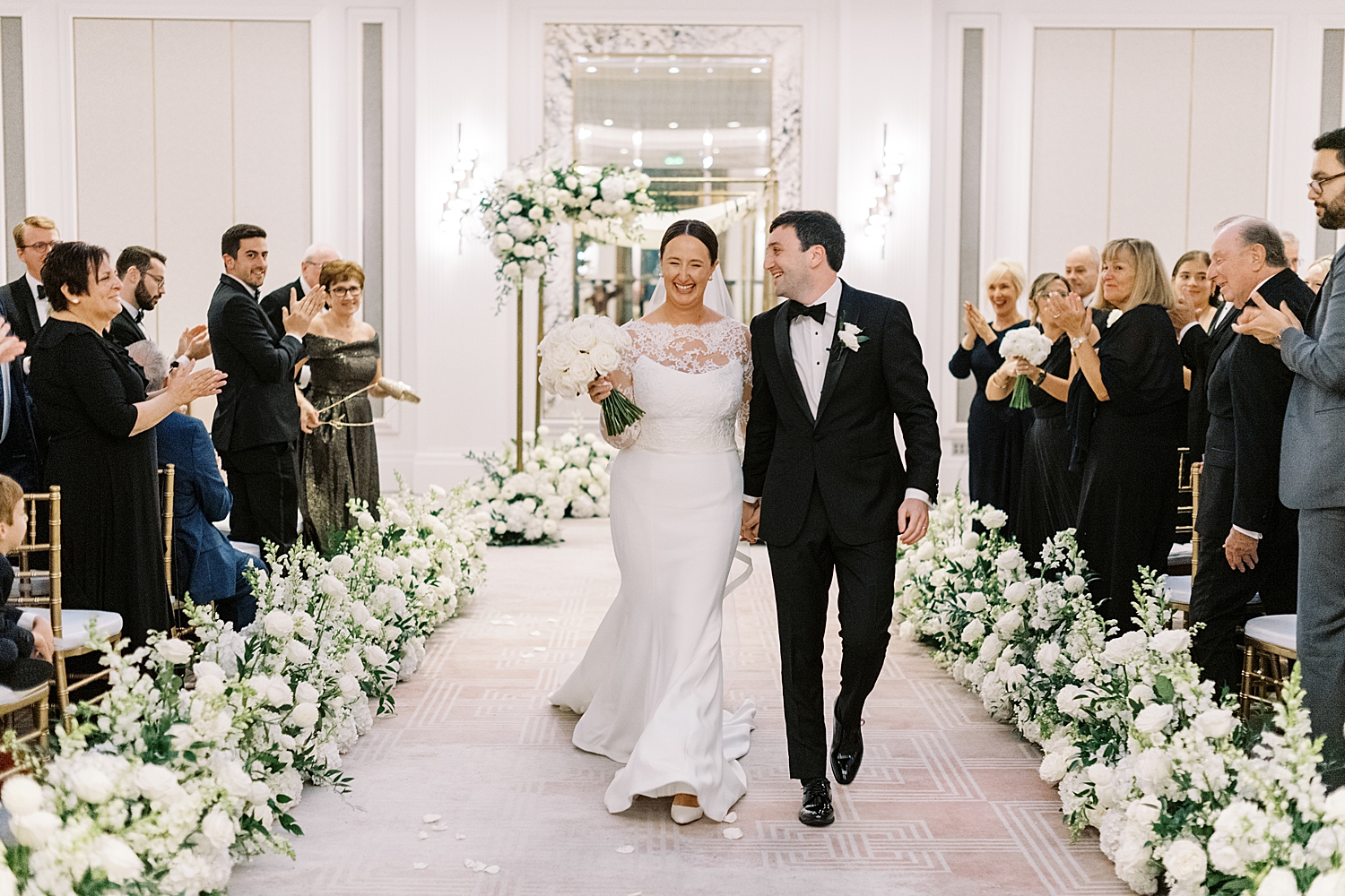 newlyweds grin as they walk back down the aisle by Boston Wedding Photographer 