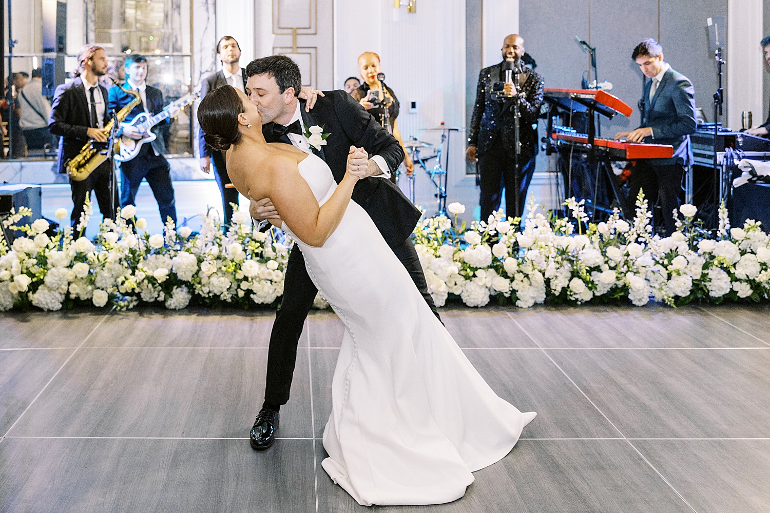 man dips new wife for a kiss by Lynne Reznick Photography