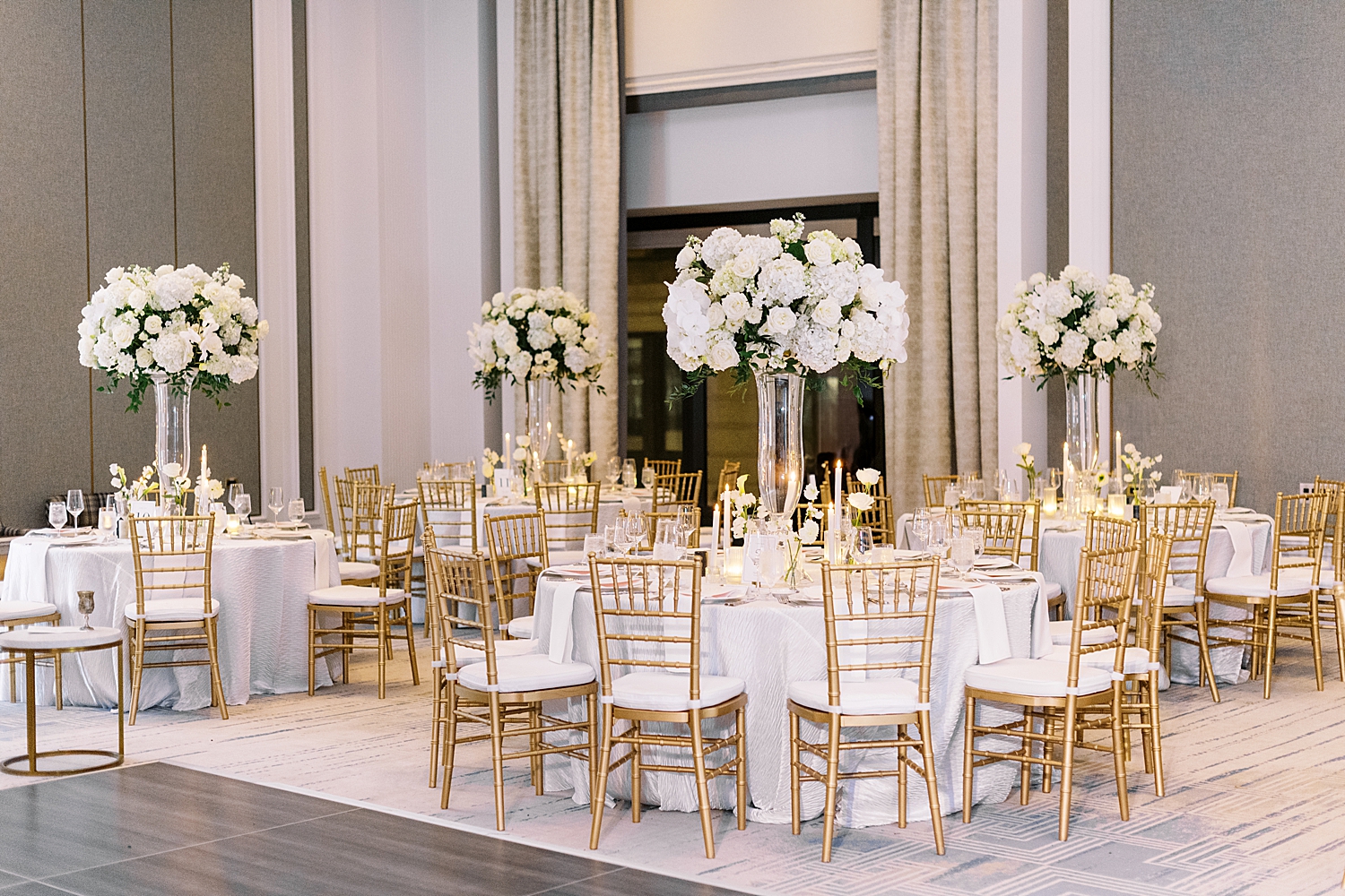 gold chairs surround white tables by Boston Wedding Photographer 