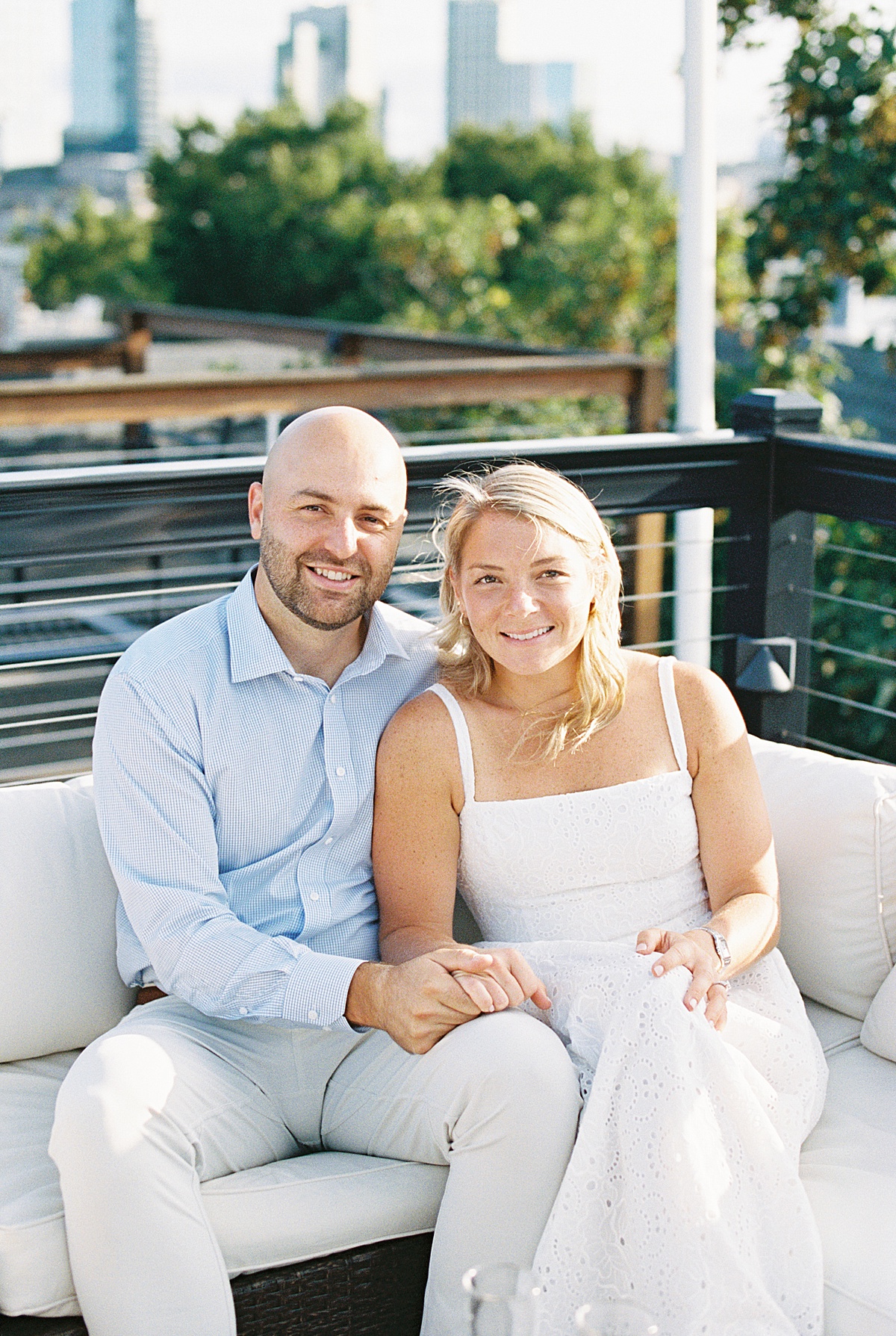 Couple sit together with big smiles for Boston Wedding Photographer