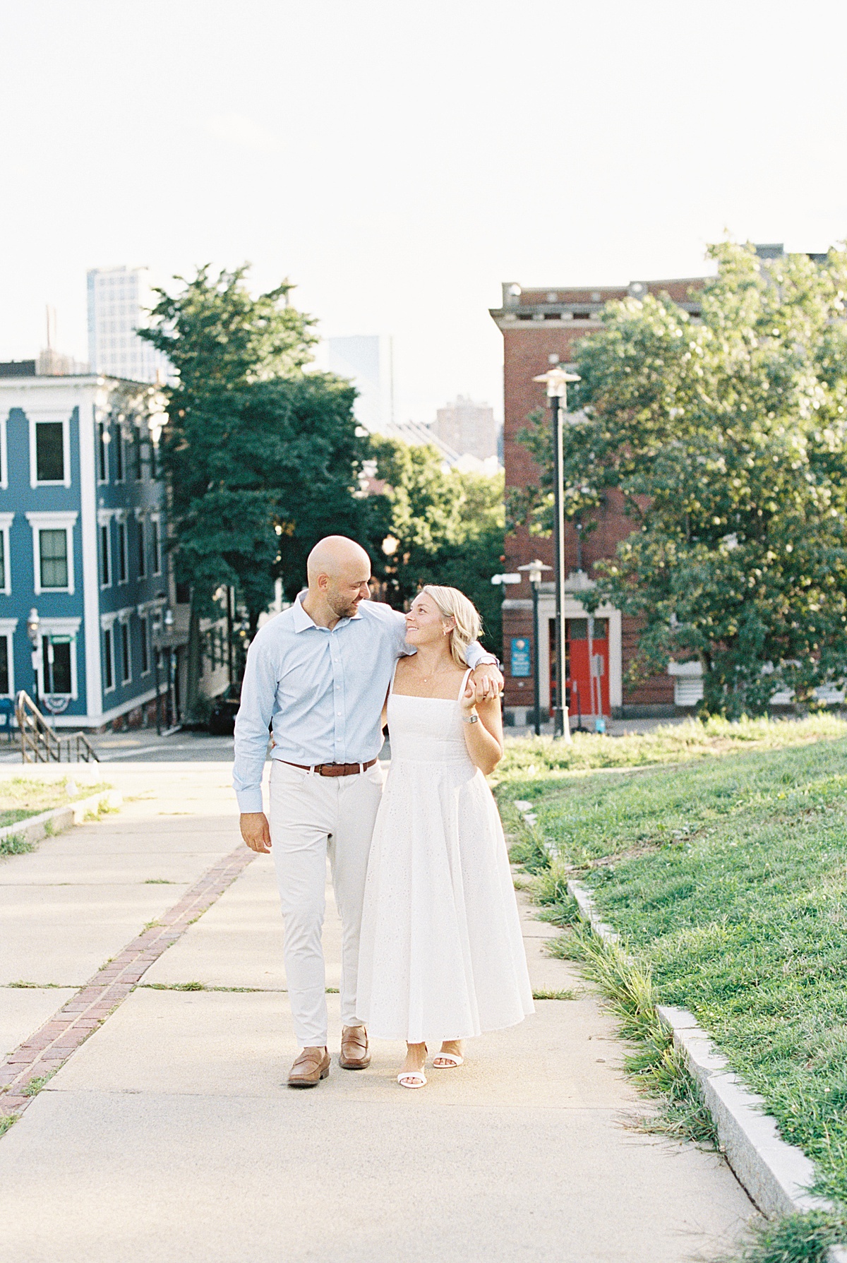 Couple walk together and share smiles during their Charlestown Engagement Session 