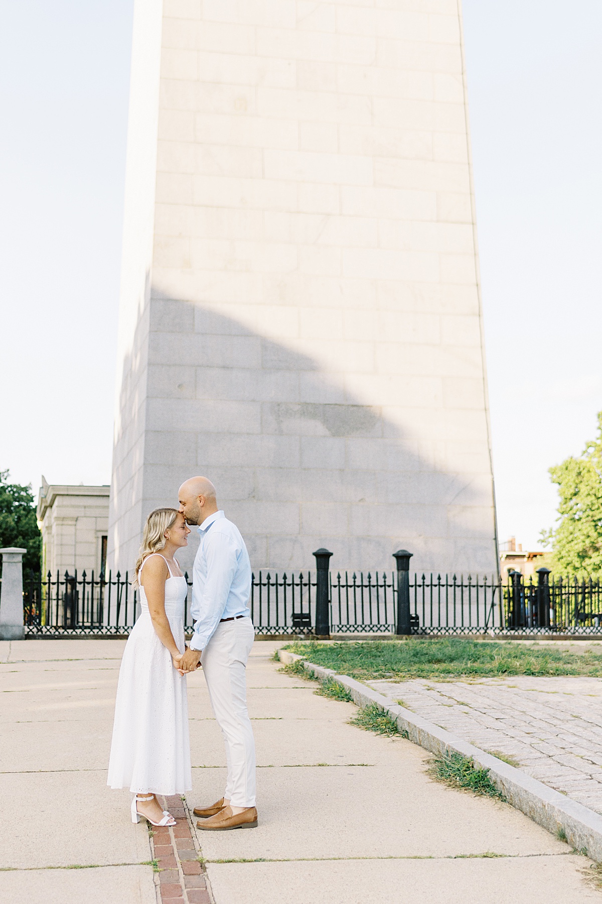 Man kisses his fiancee on his forehead during their Boston Engagement Session