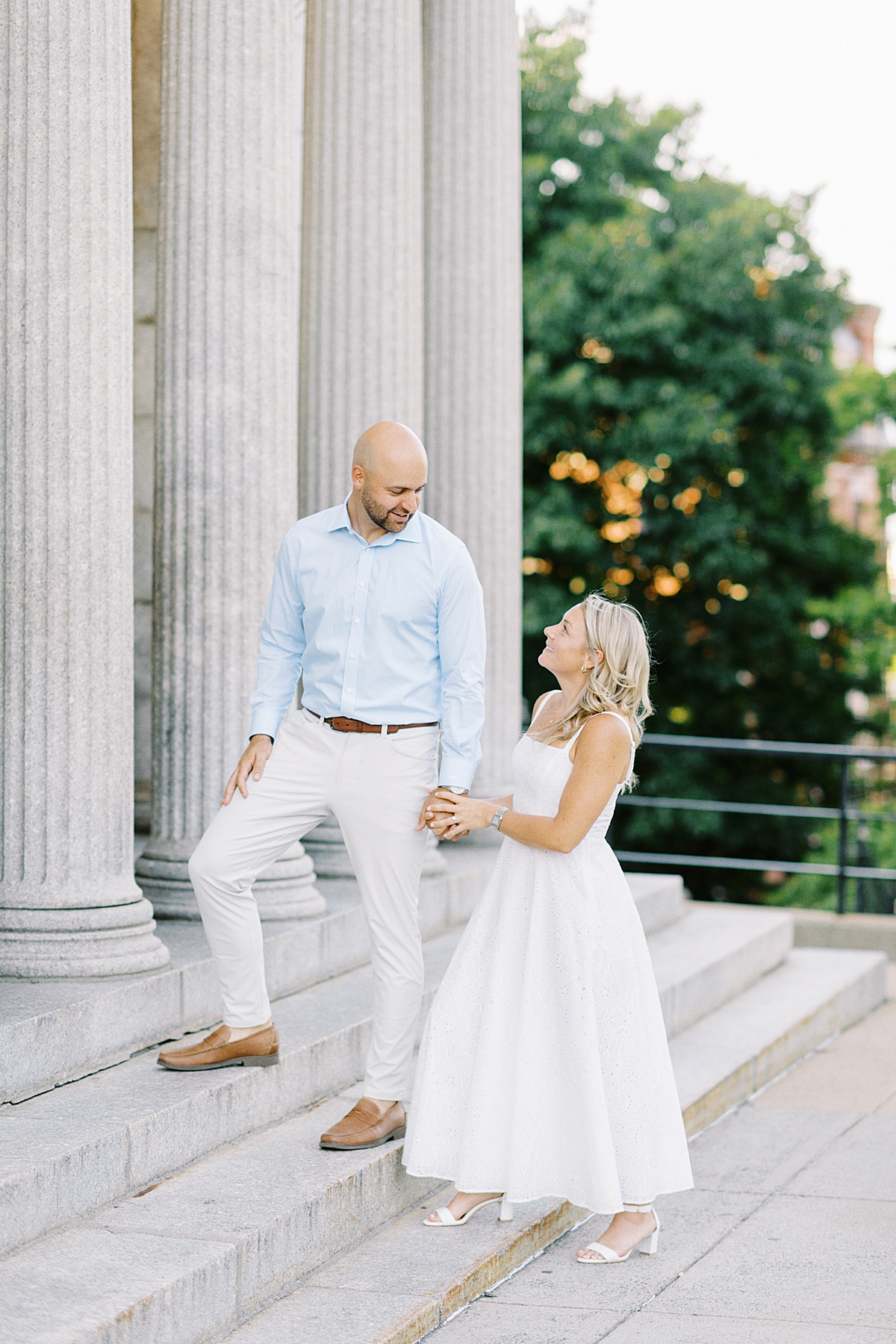 Couple hold hands and walk up the steps for Lynne Reznick Photography
