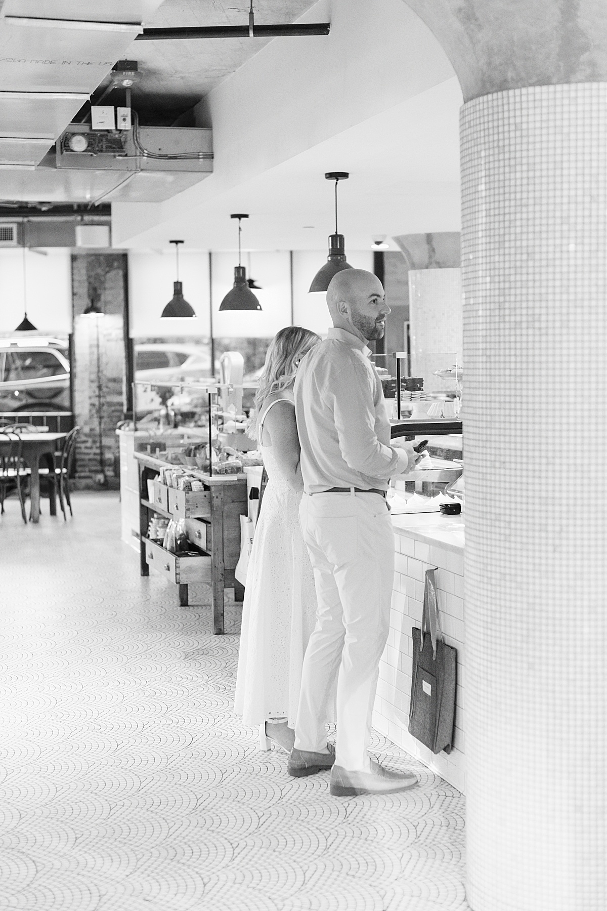 Couple stand together and order their coffee during their Charlestown Engagement Session 