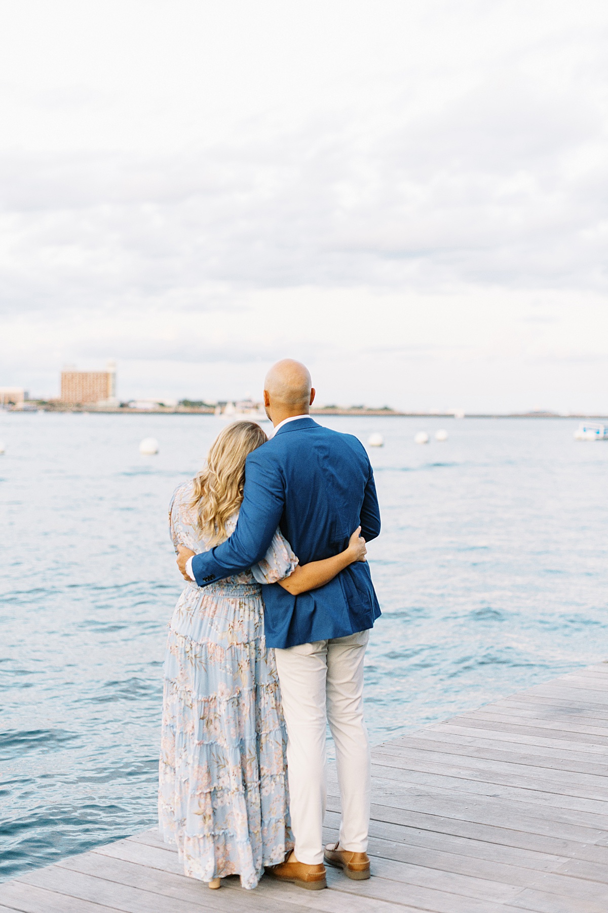 Engaged couple look out to the water for Boston Wedding Photographer