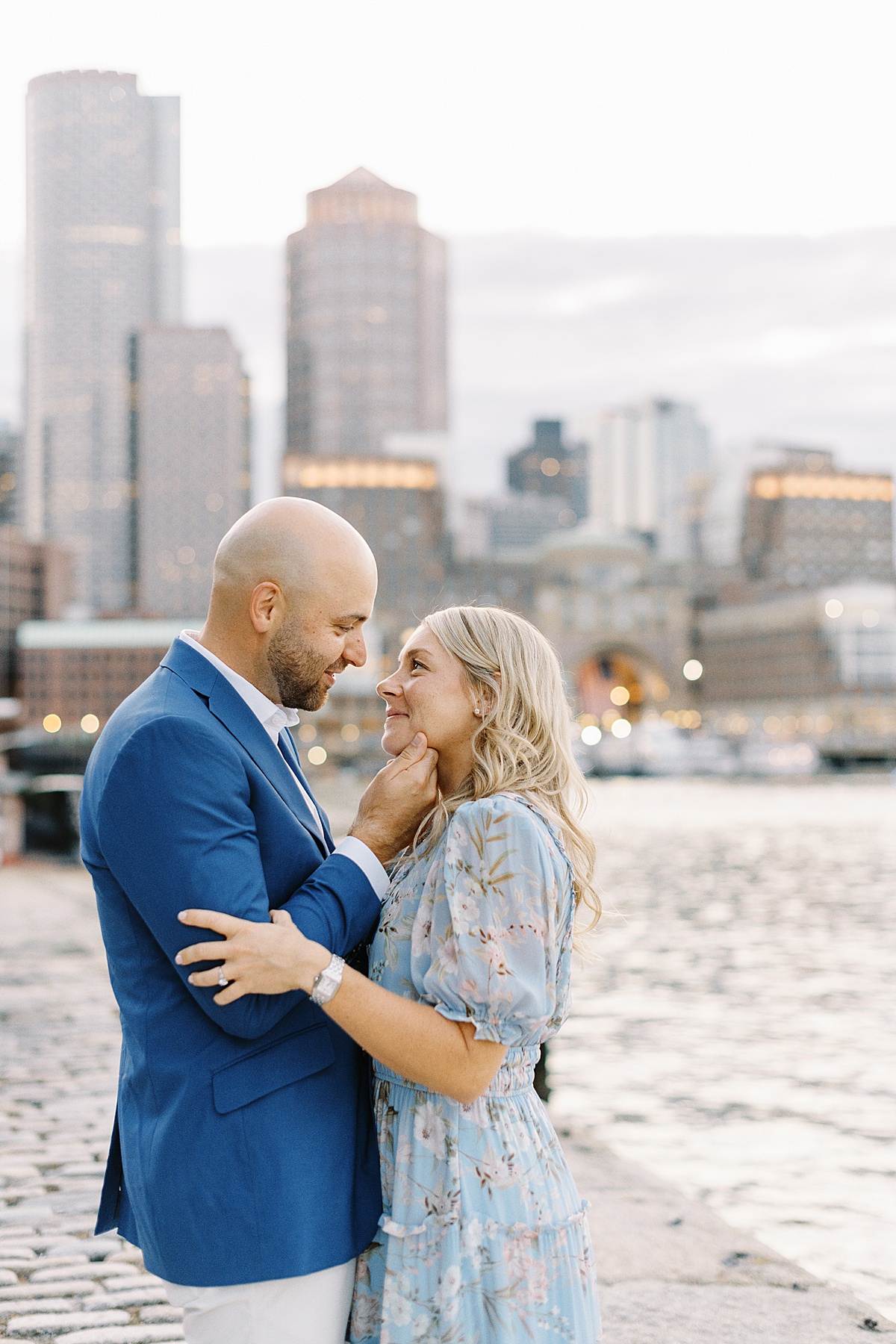 Engaged couple cuddle in close together for Lynne Reznick Photography