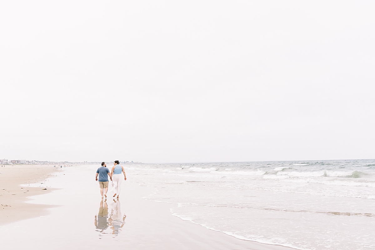 Couple walk on Footbridge Beach together