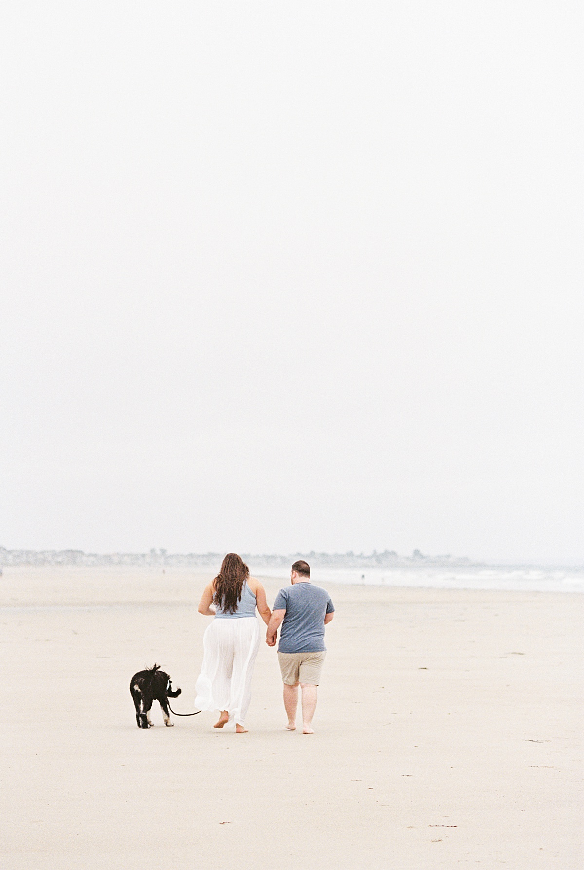 Man and woman walk hand in hand together for Lynne Reznick Photography