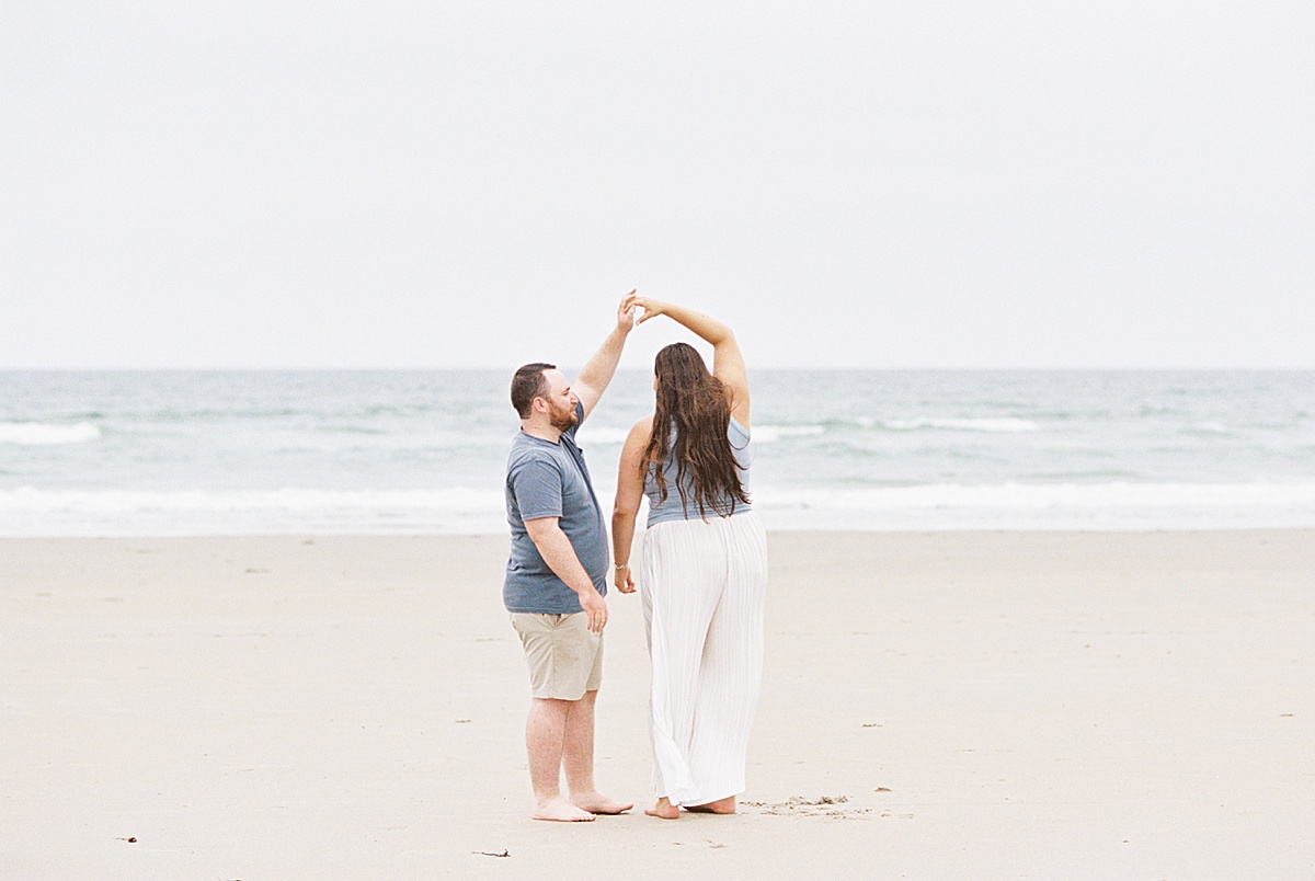 Man and woman dance together for Coastal Maine Wedding Photographer