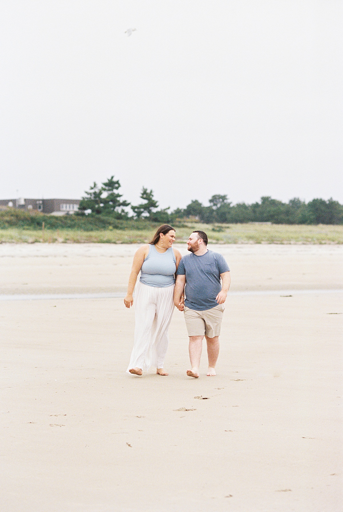 Couple smile at one another on Footbridge Beach 