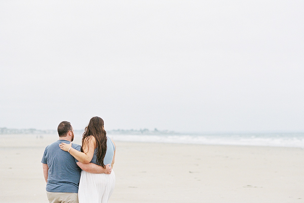 Couple hold each other close on Footbridge Beach 