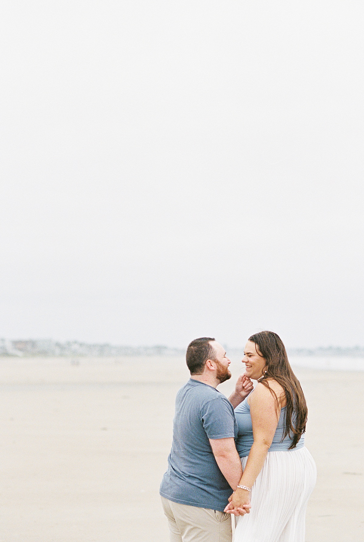 Happy couple smile at one another for Lynne Reznick Photography