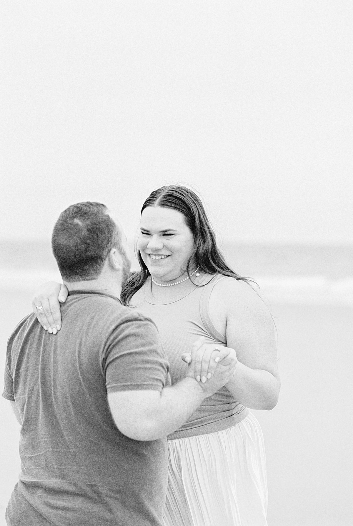 Man and woman dance together on Footbridge Beach 