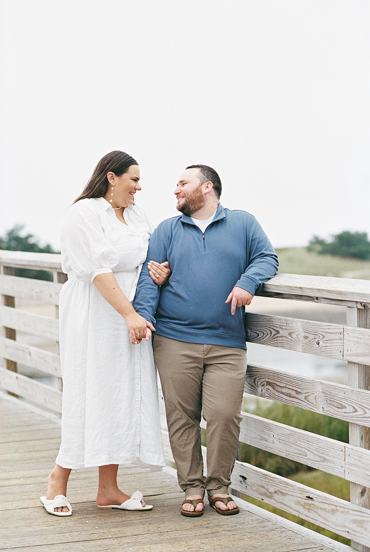 Man and woman smile at one another on Footbridge Beach 