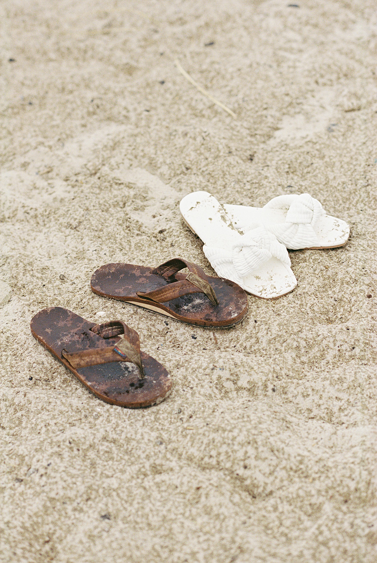 couple leave their sandals in the sand for Lynne Reznick Photography