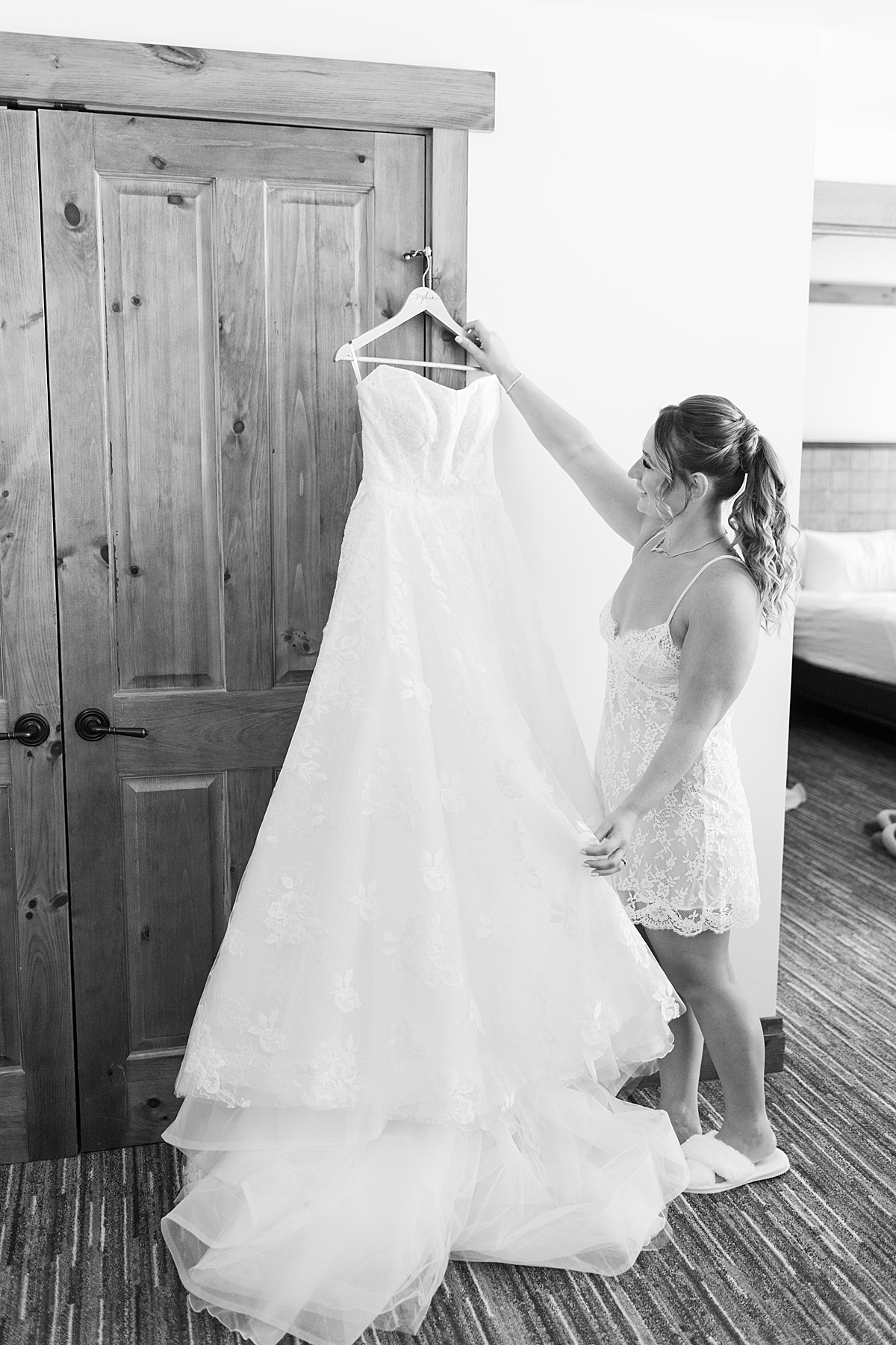 Bride admires wedding gown for Lynne Reznick Photography
