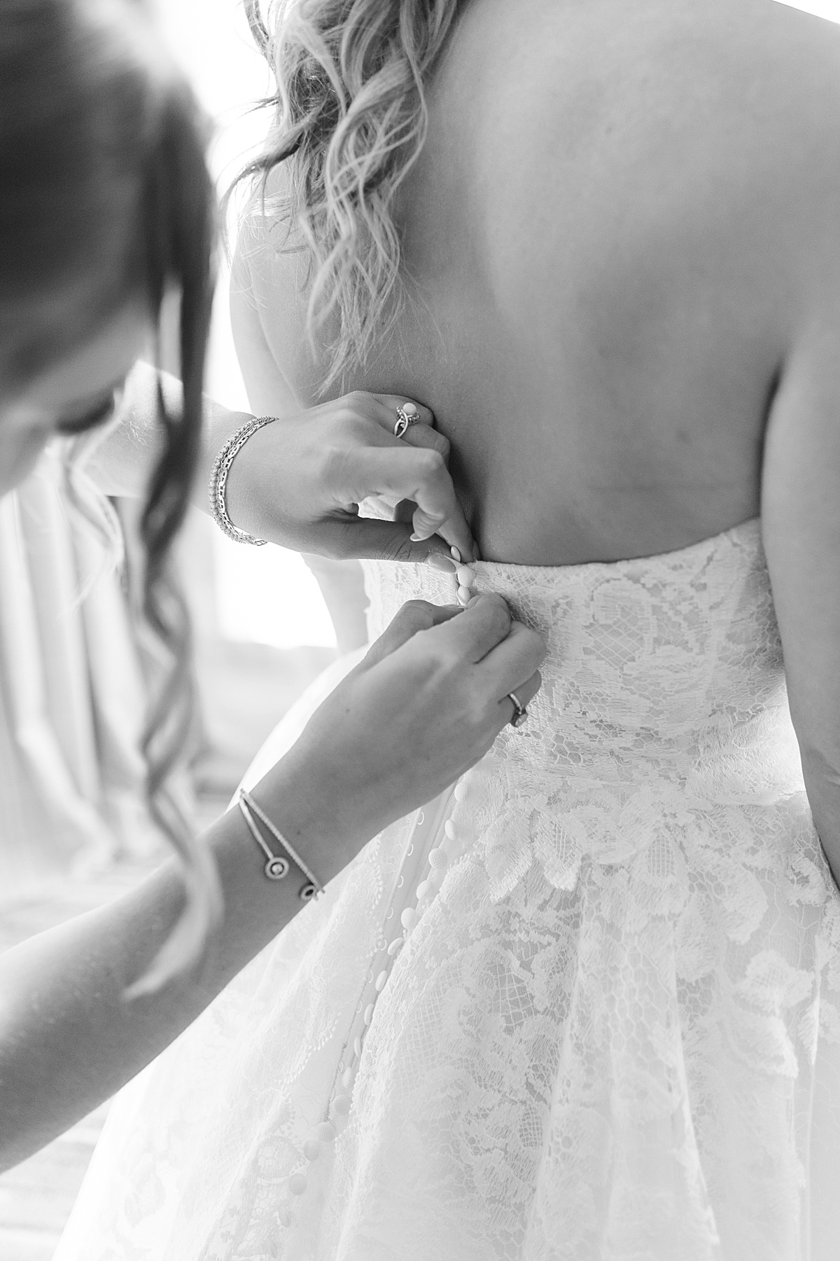 Bride is helped into her bridal gown at The Lodge at Spruce Peak