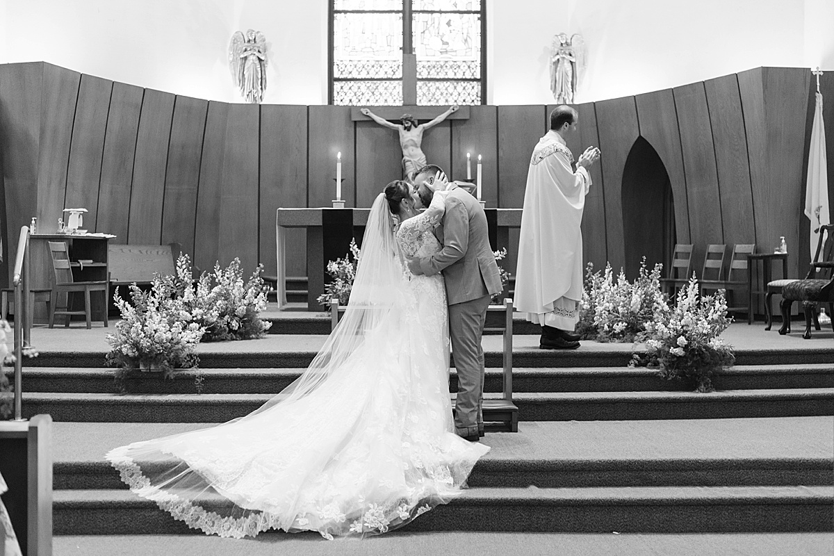 Husband and wife share their first kiss before heading back to The Lodge at Spruce Peak